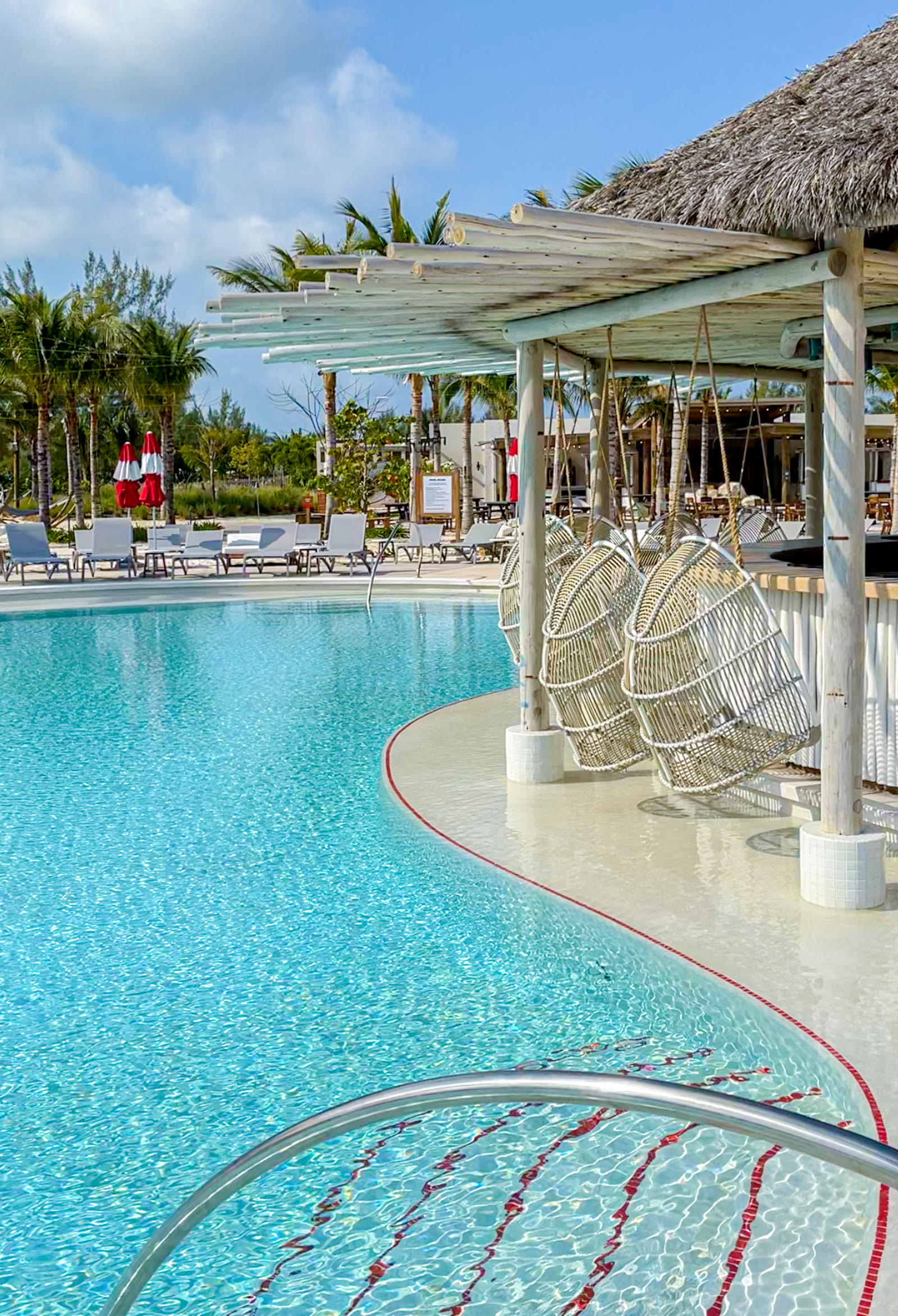 Bimini Beach Club poolside bar beside the turquoise pool.