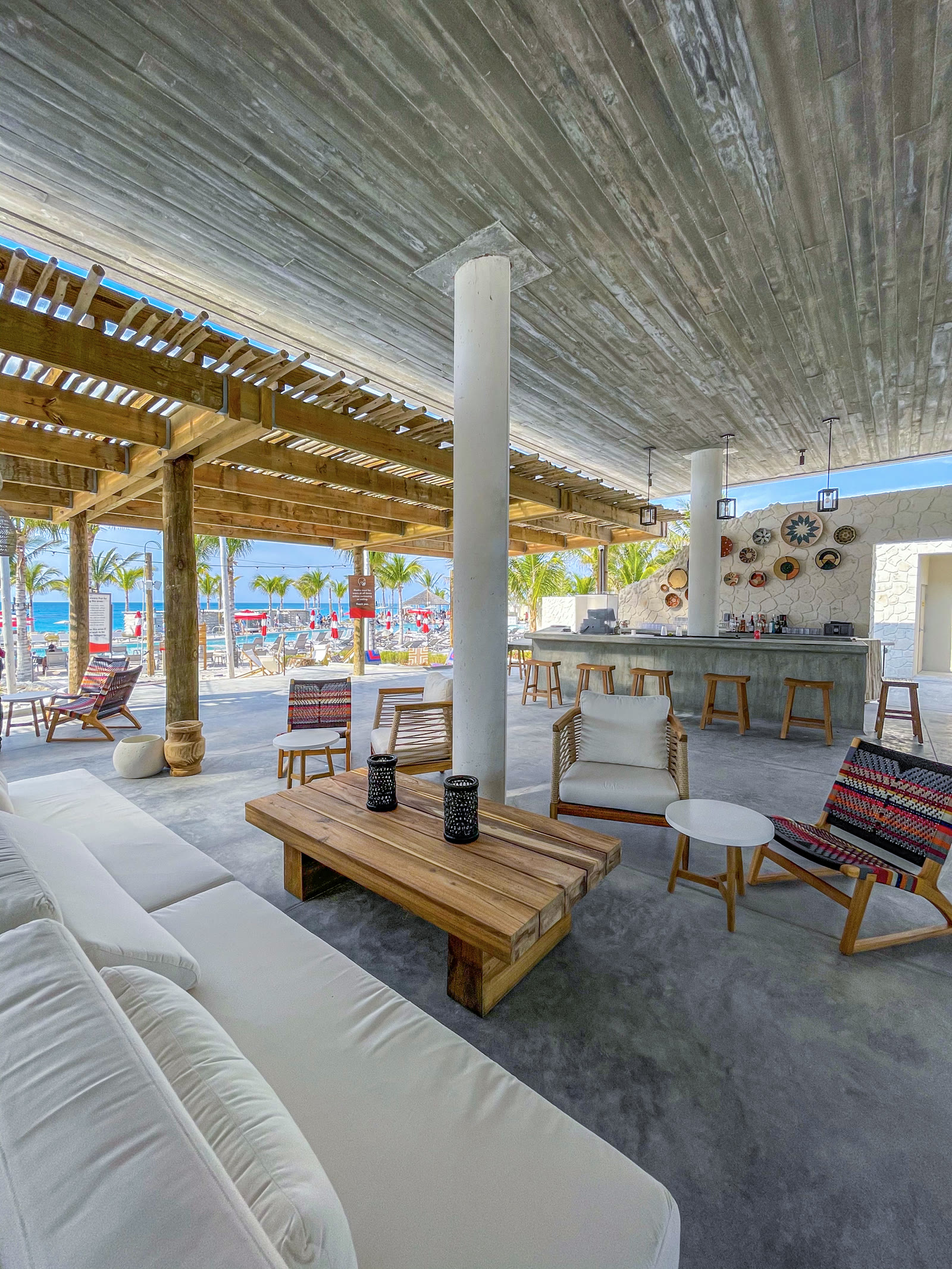 Bimini Beach Club lounge area with bar and seating.