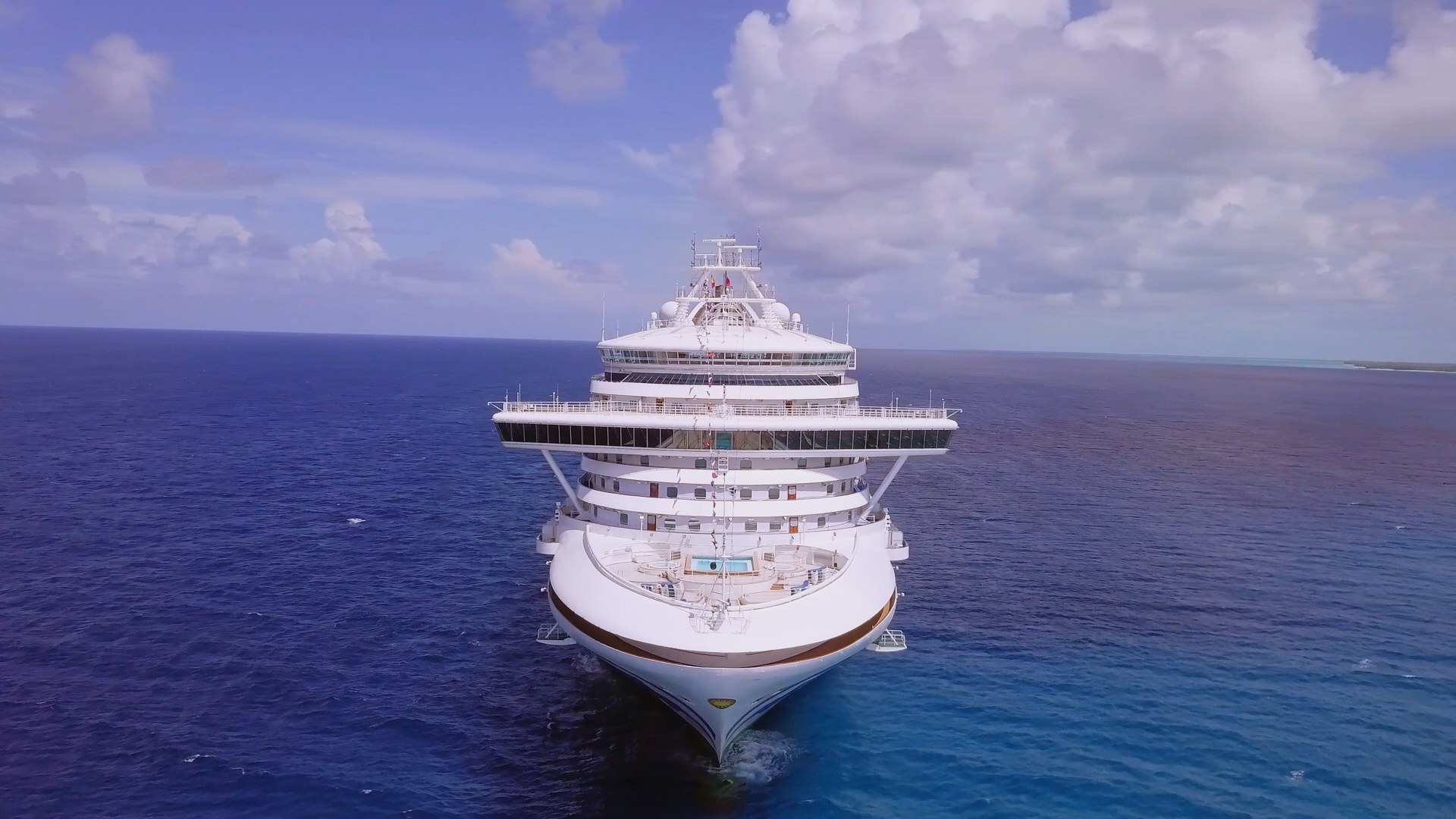Caribbean Princess bow-on aerial on calm blue open water