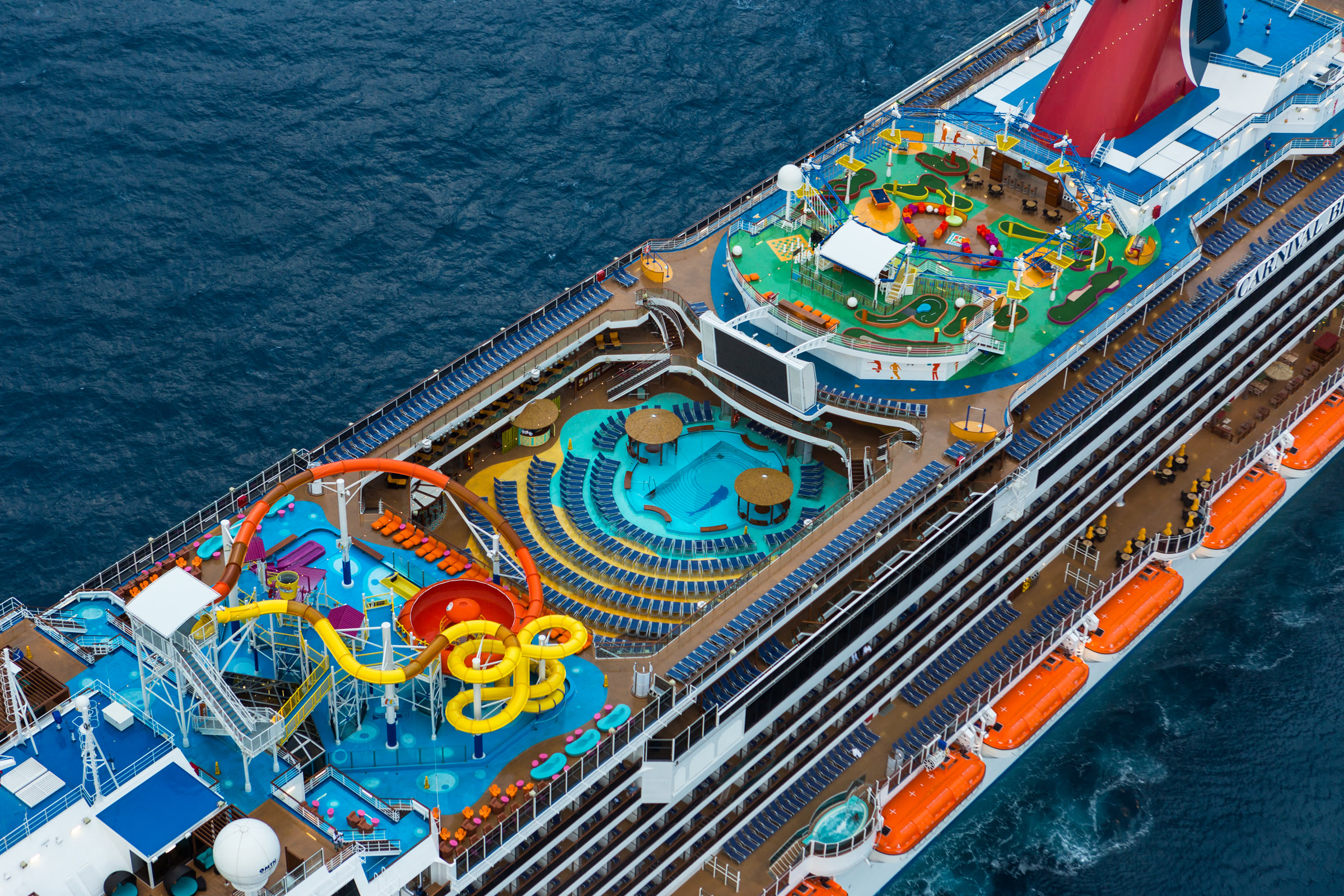 Carnival Breeze sunny top-deck waterpark aerial approaching Tortola