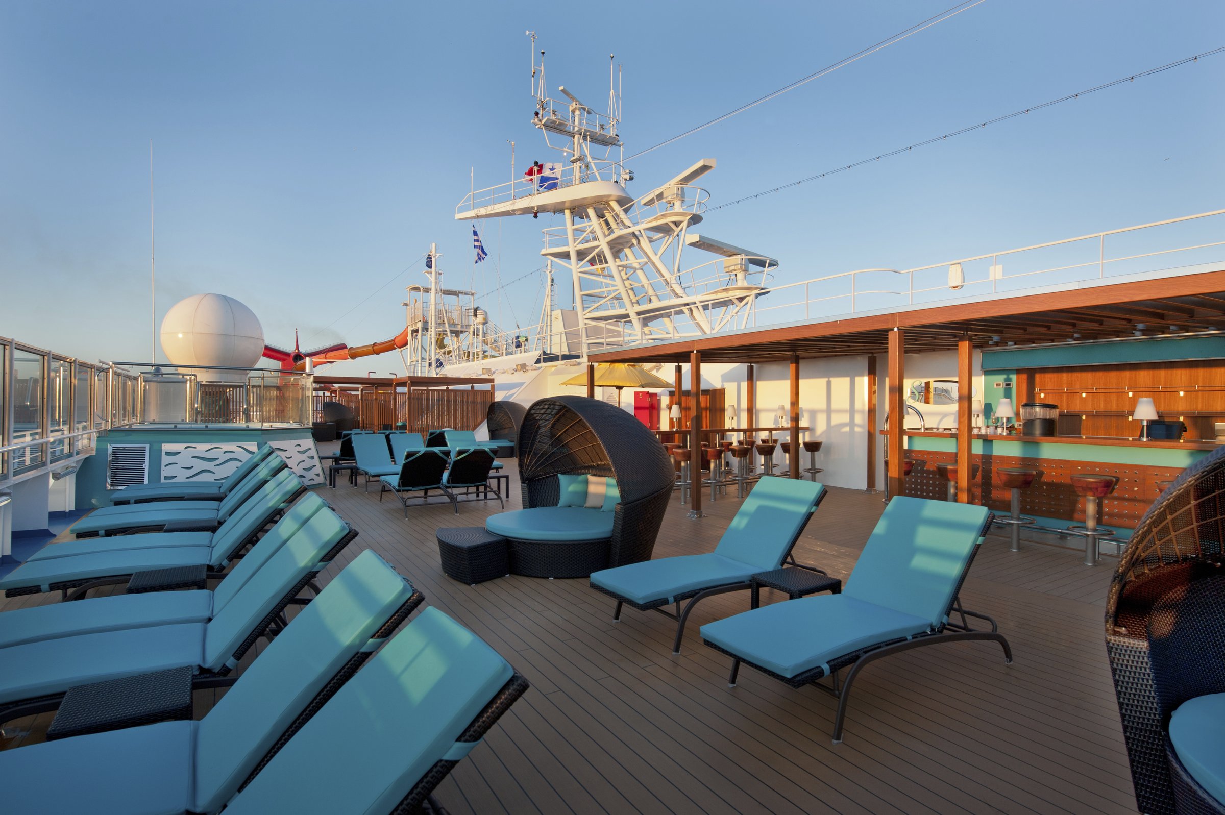 Carnival Breeze Serenity adults-only deck with teal loungers and a hanging daybed