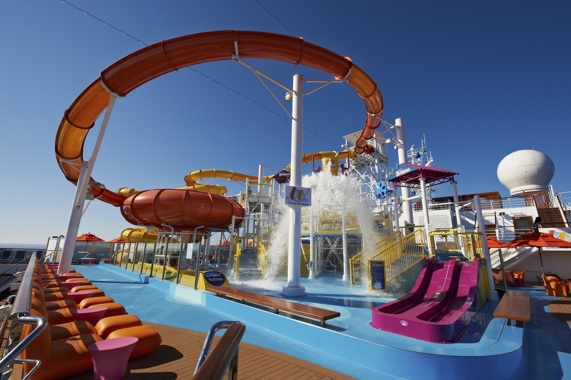 Carnival Breeze WaterWorks splash deck and curving slides under a blue sky
