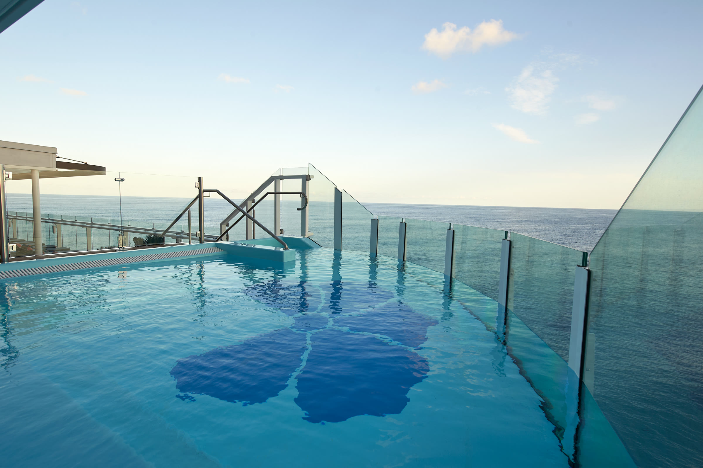 Sunny Serenity infinity pool overlooking the ocean aboard Carnival Celebration