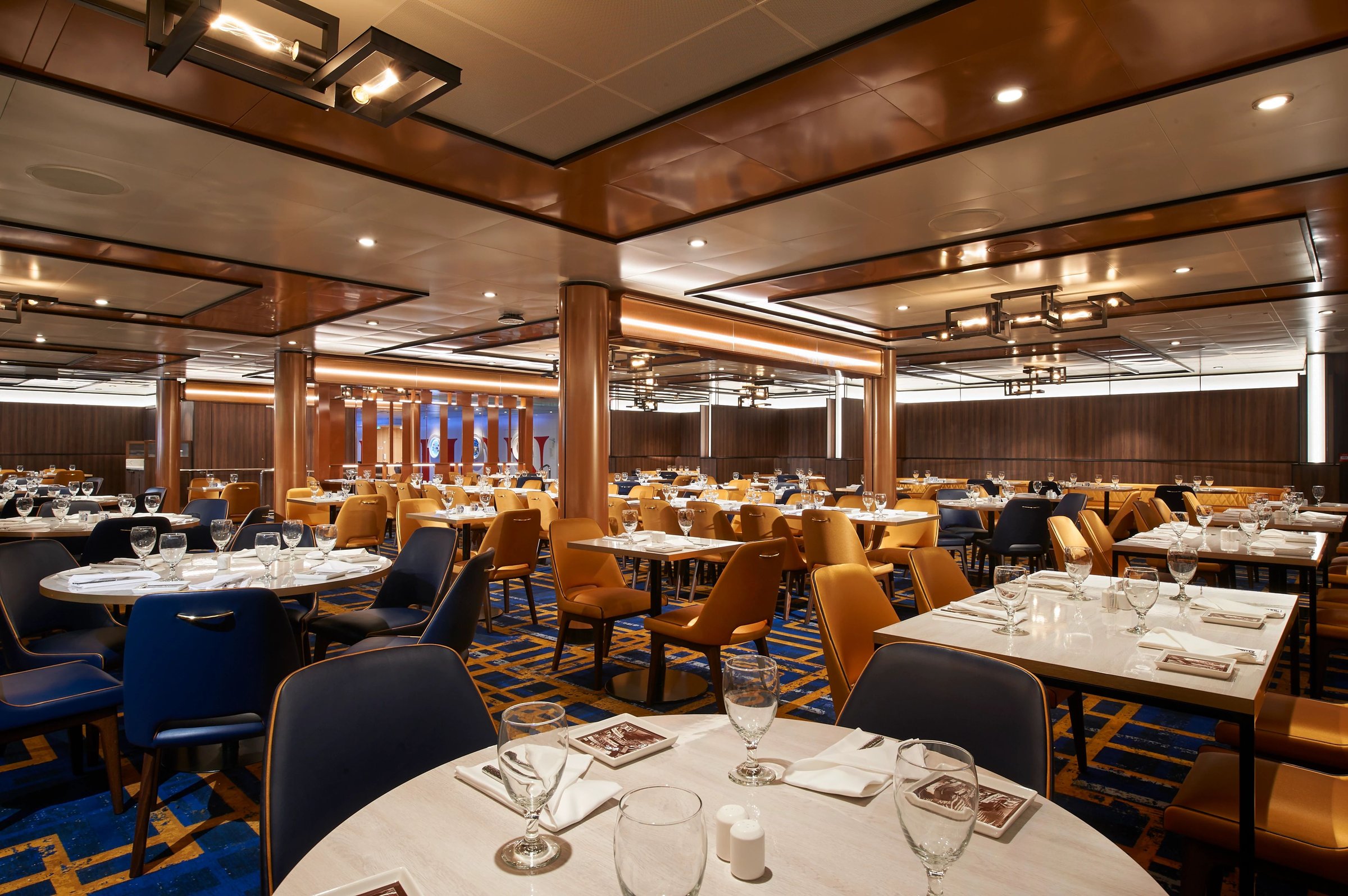 Carnival Celebration Carnivale dining room with set tables and wood-panelled ceiling