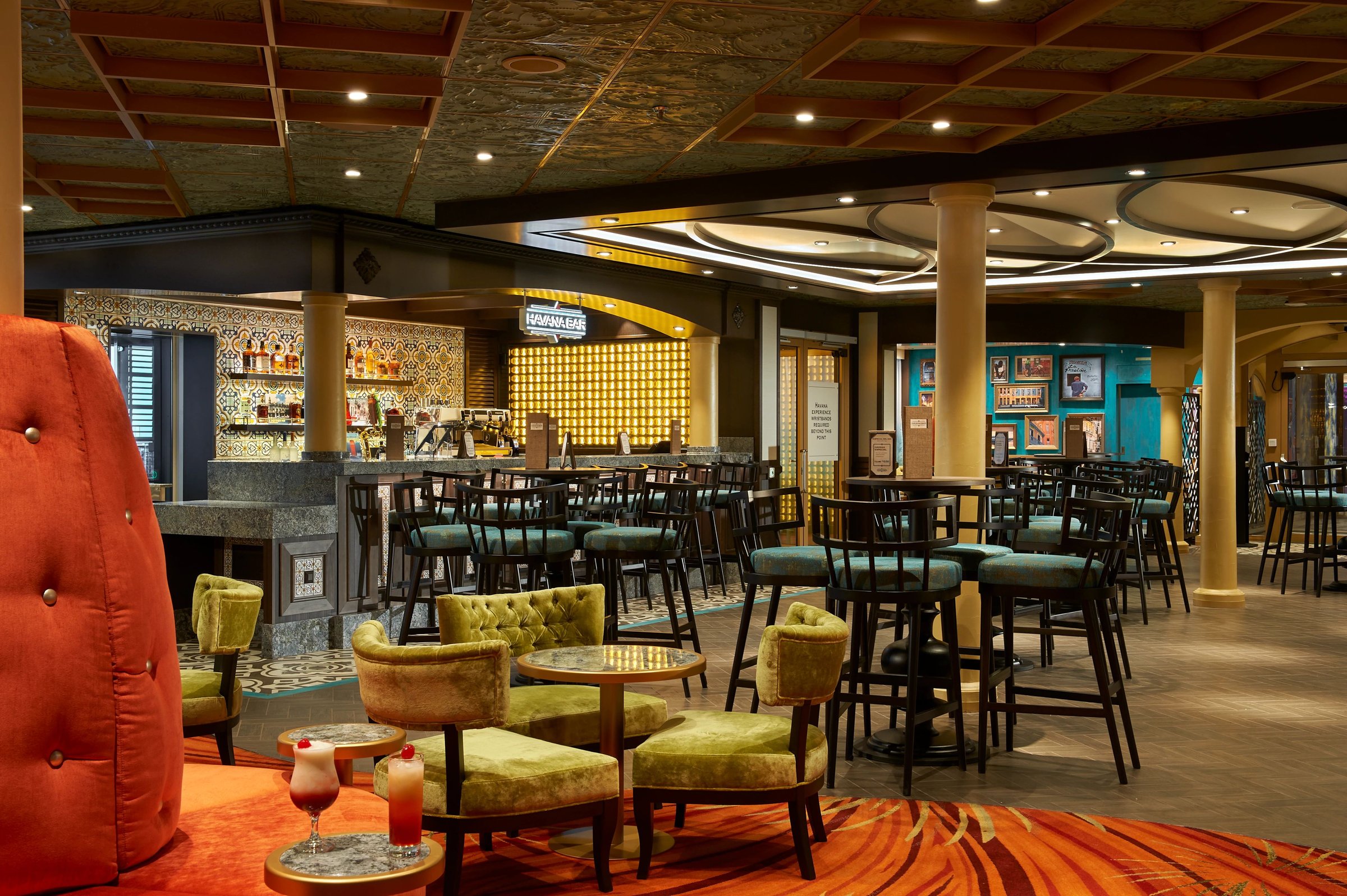 Carnival Celebration Havana Bar interior with tufted armchairs and bar seating