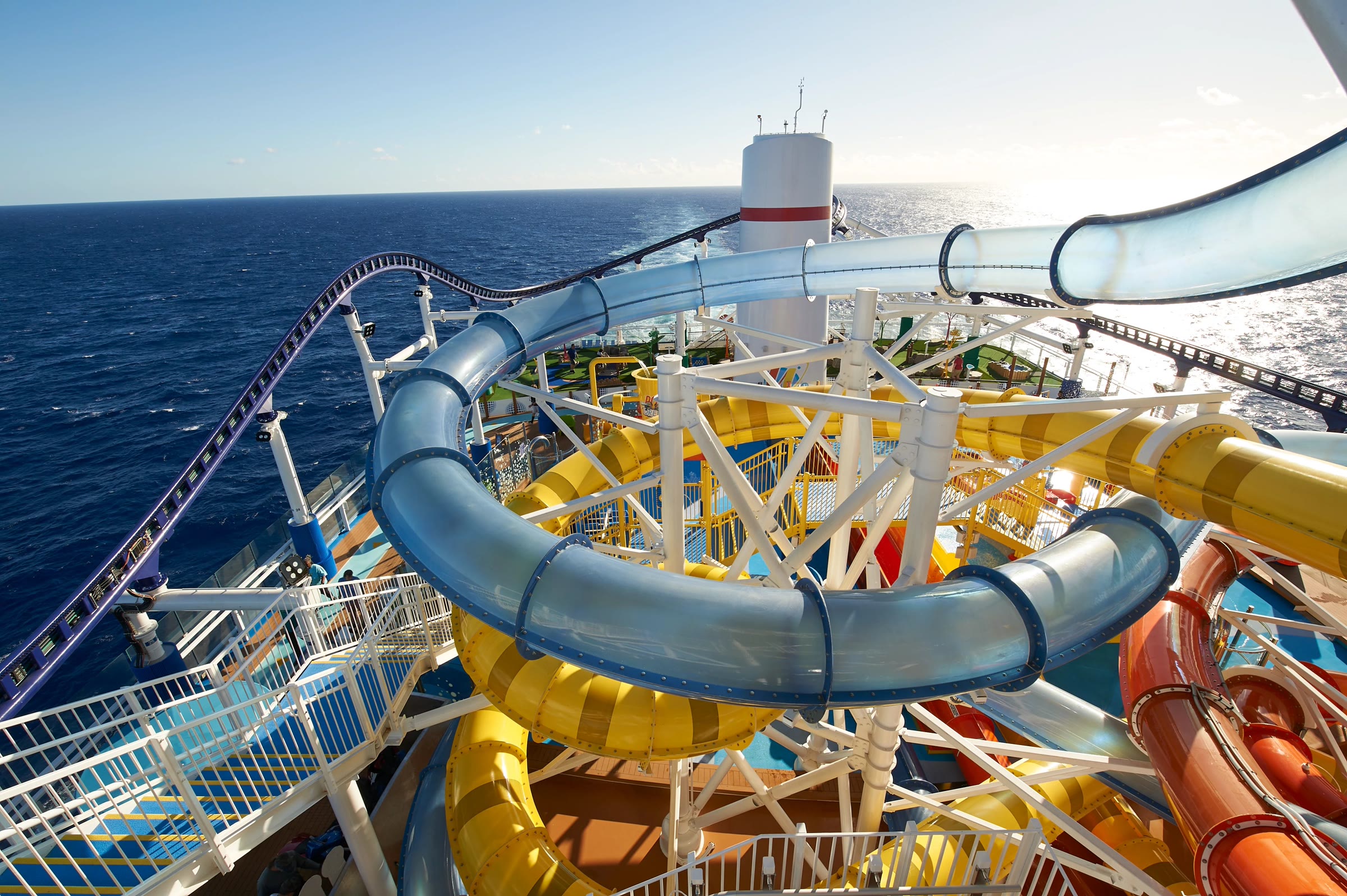 Sunny WaterWorks deck with slides and ocean wake aboard Carnival Celebration
