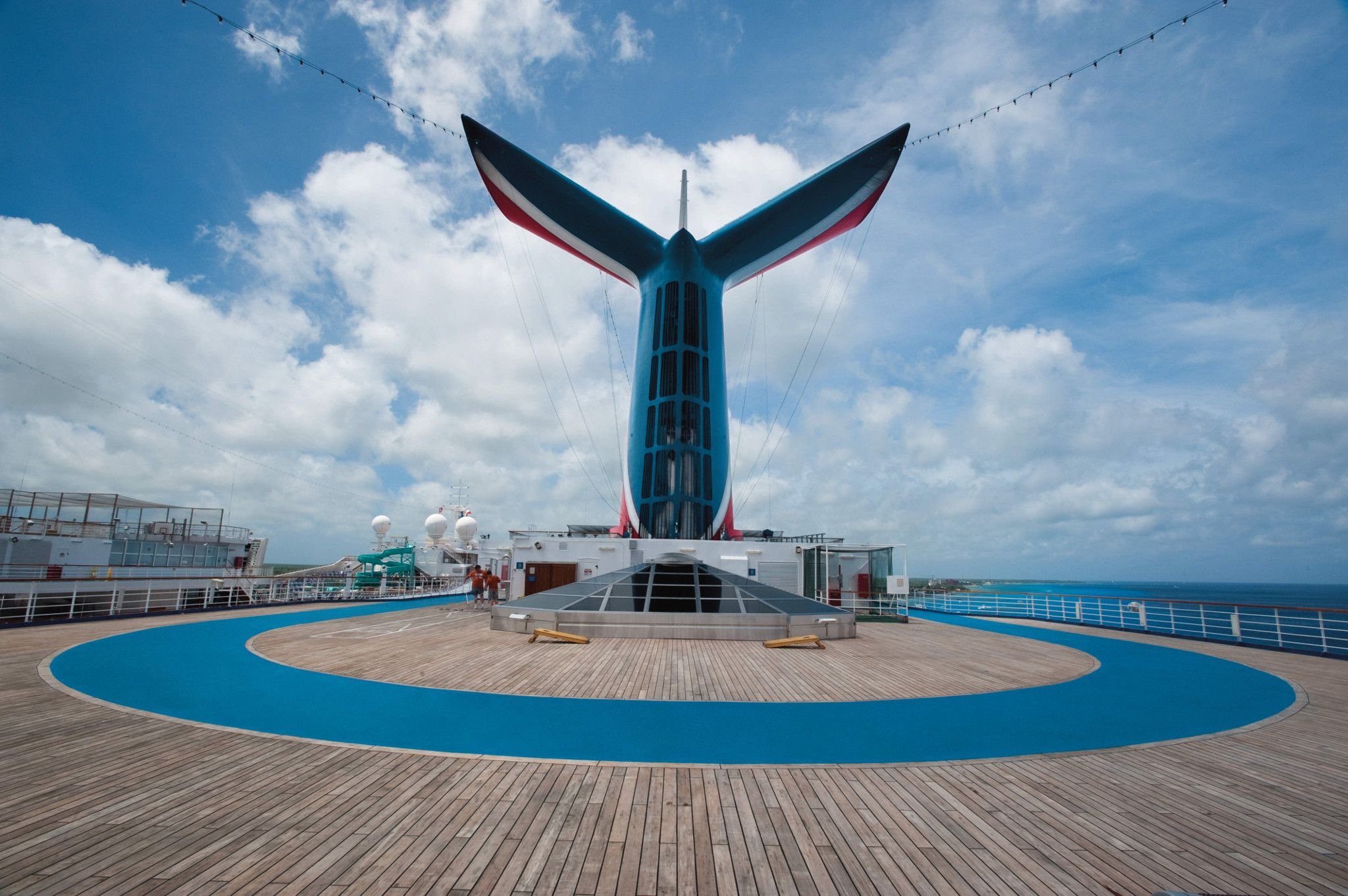 Carnival Conquest Whale Tail funnel and blue jogging track on a sunny day