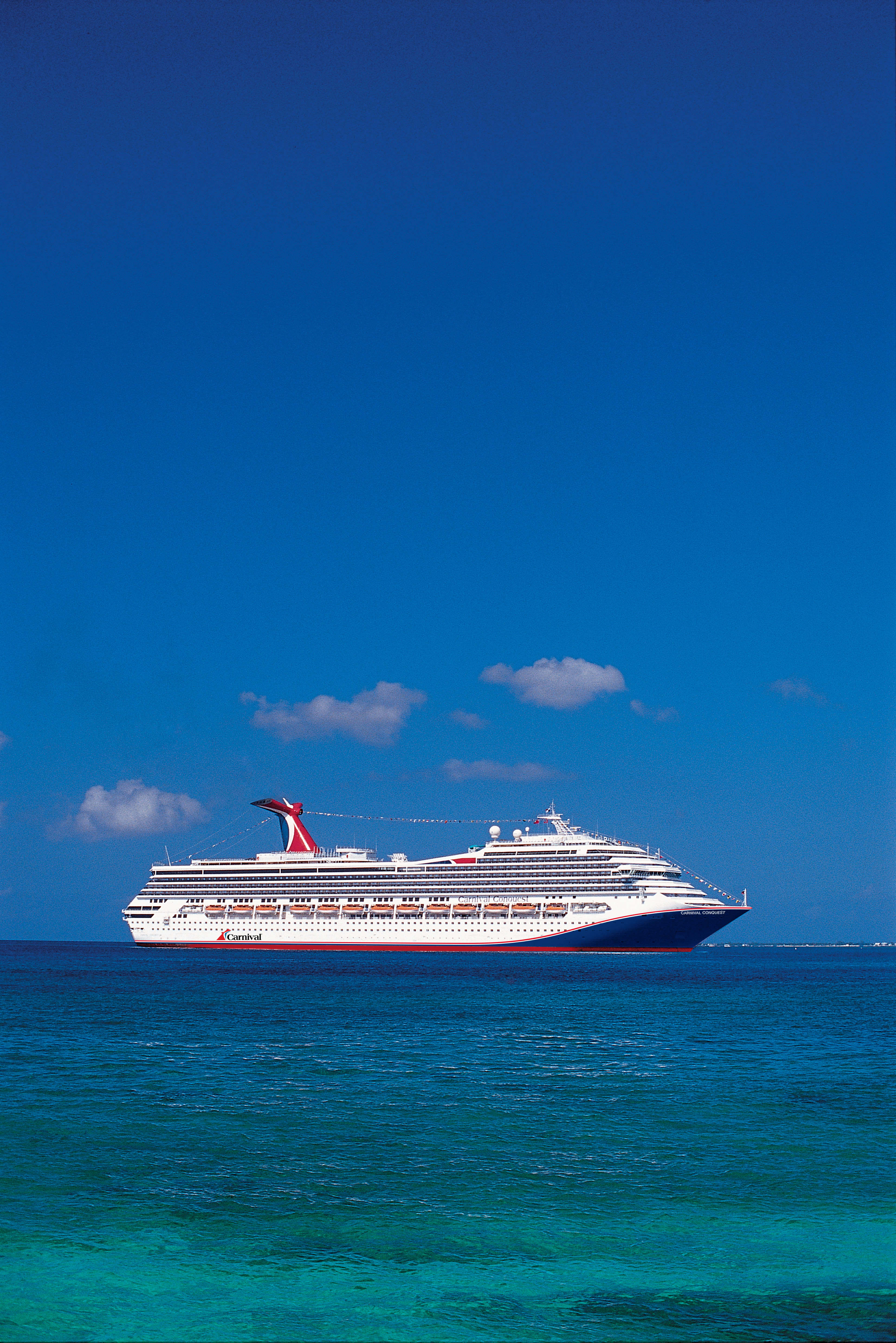 Carnival Conquest blue hull aerial side view at sea
