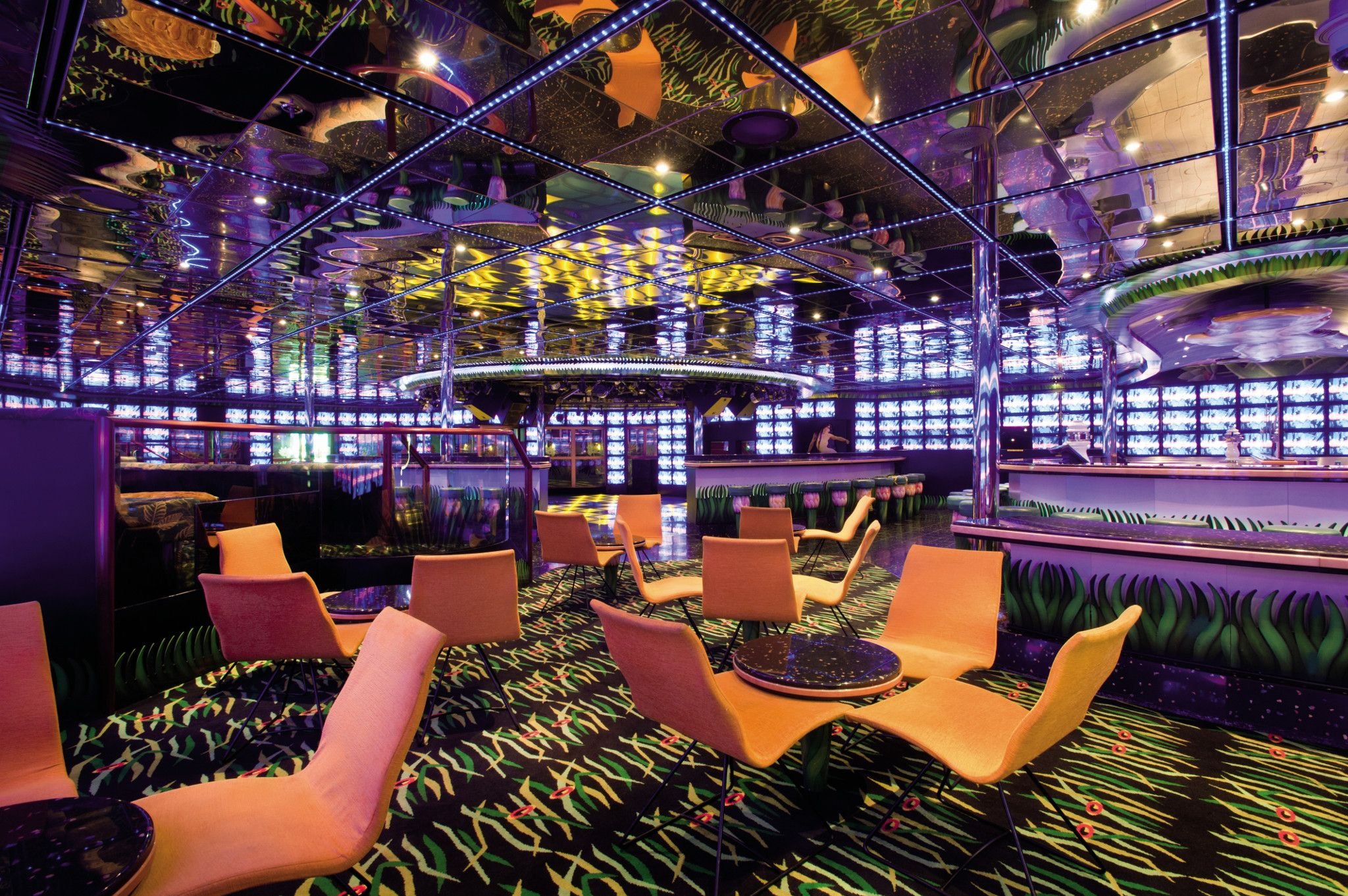 Carnival Conquest disco lounge with orange seating and mirrored ceiling