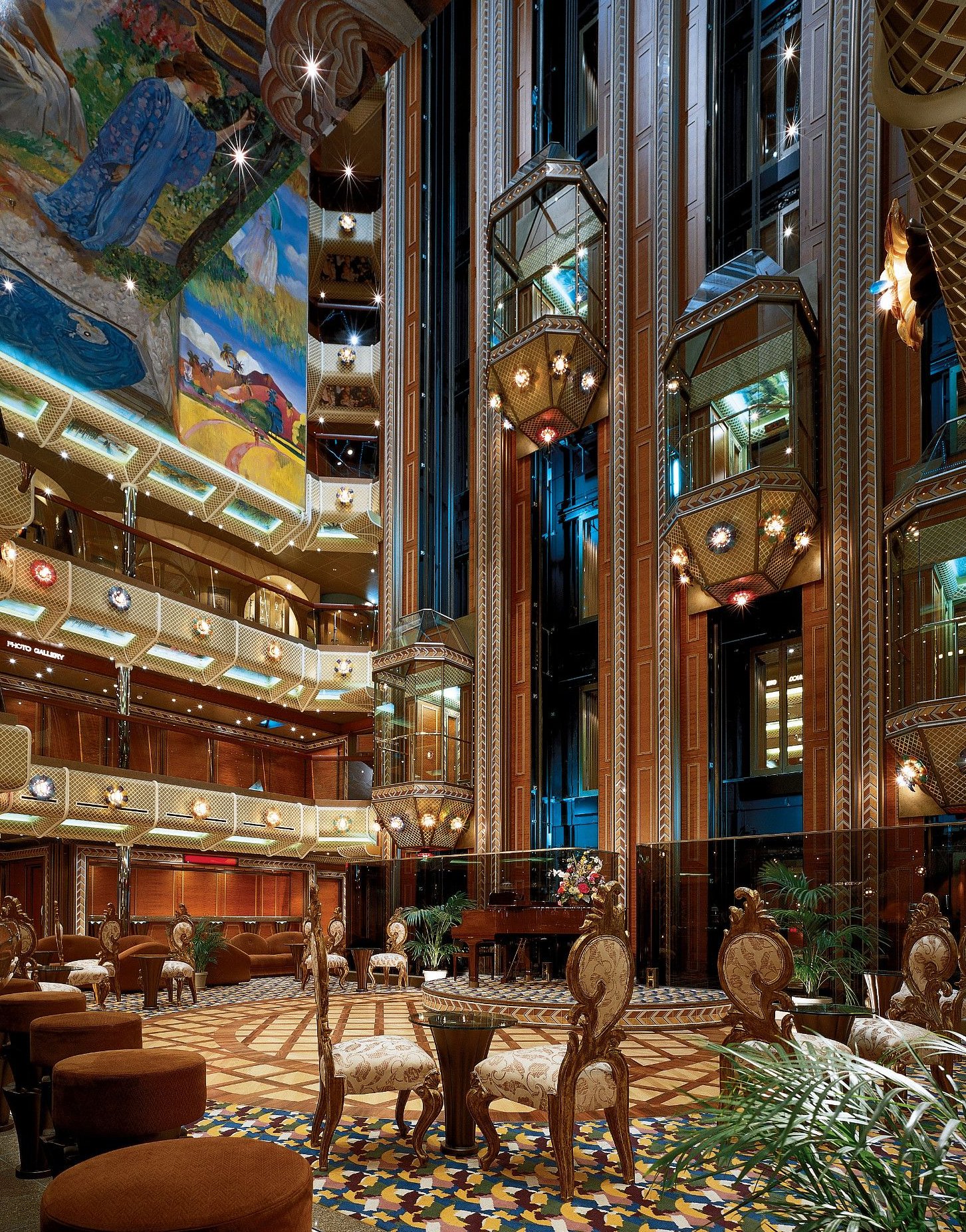 Carnival Conquest multi-deck atrium lobby with glass elevators and ornate seating