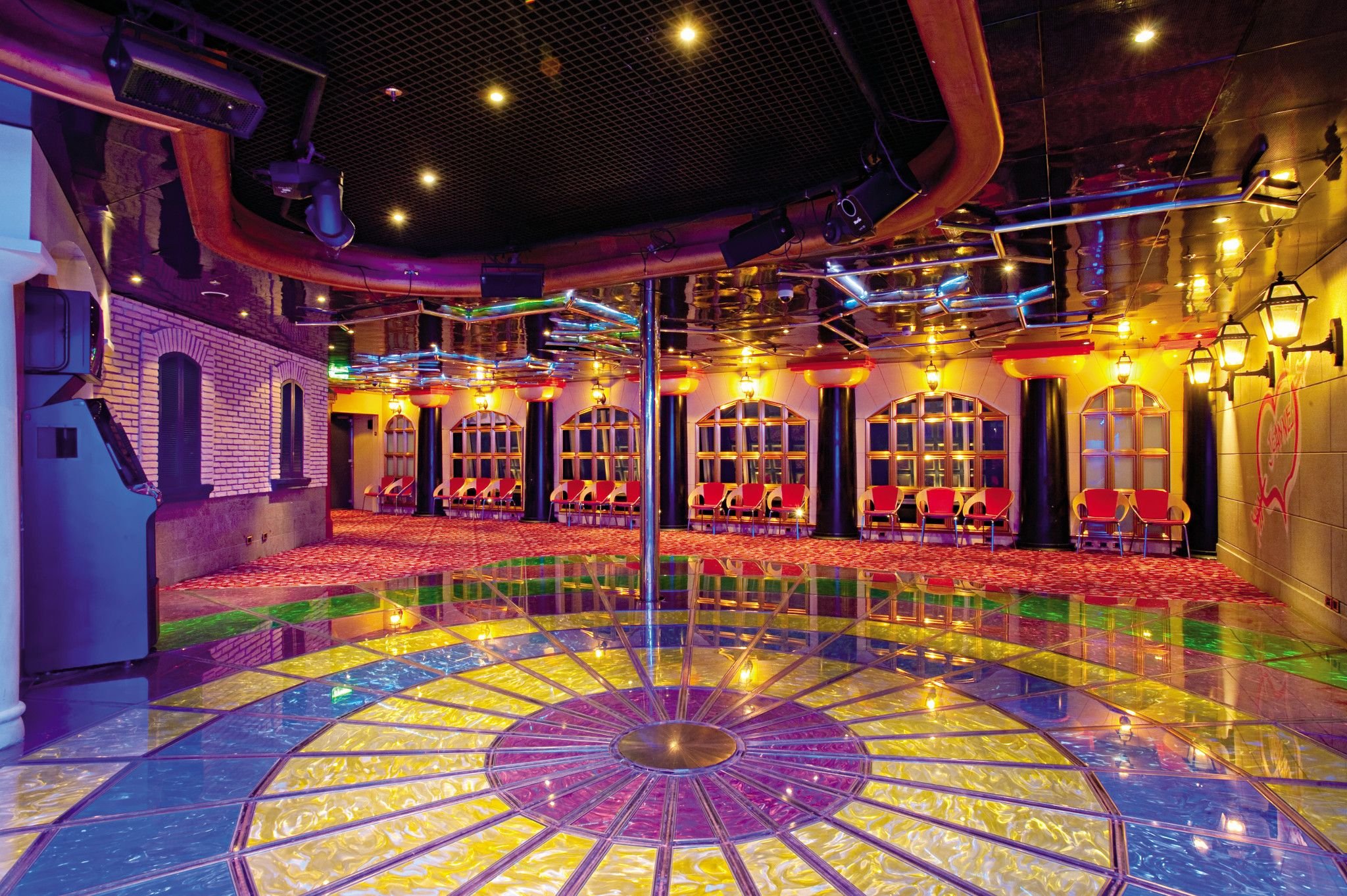 Carnival Conquest Club O2 dance floor with colorful patterned floor and lighting