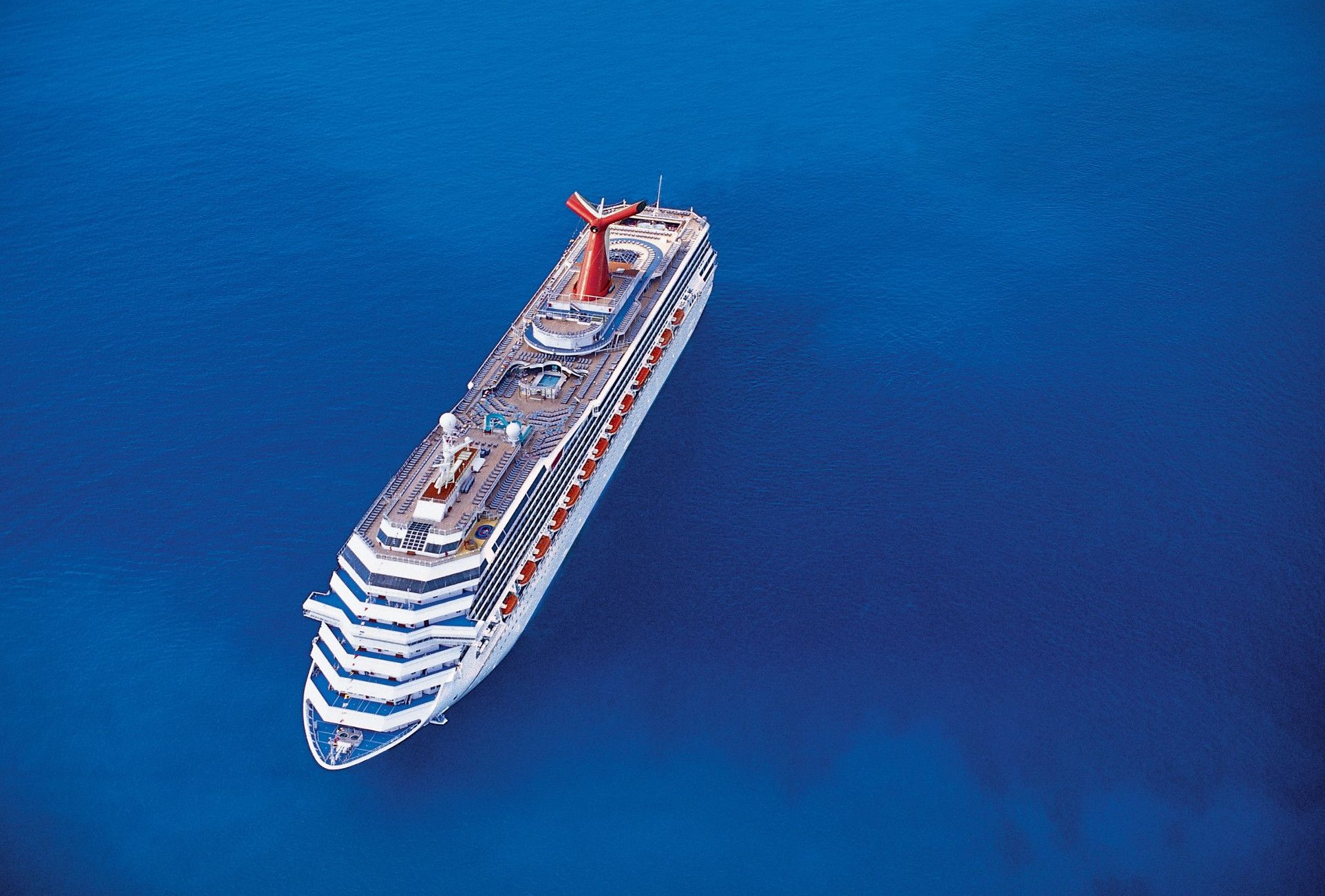 Carnival Conquest aerial at sea from above on deep blue water