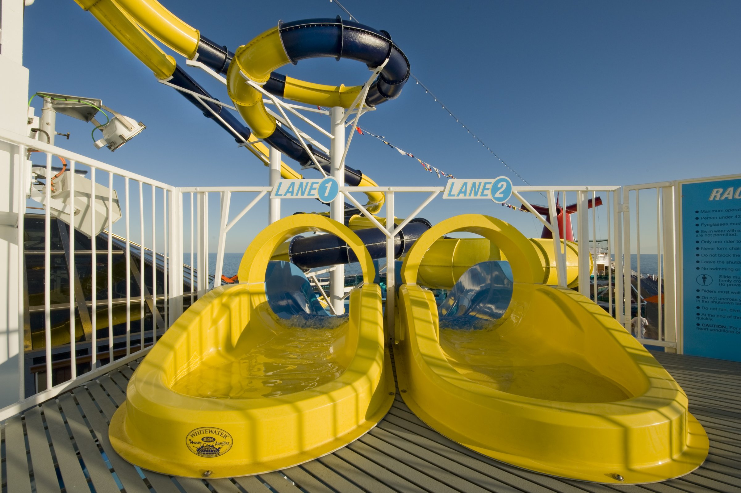 Carnival Dream WaterWorks racer slide launch with yellow sleds and white railings