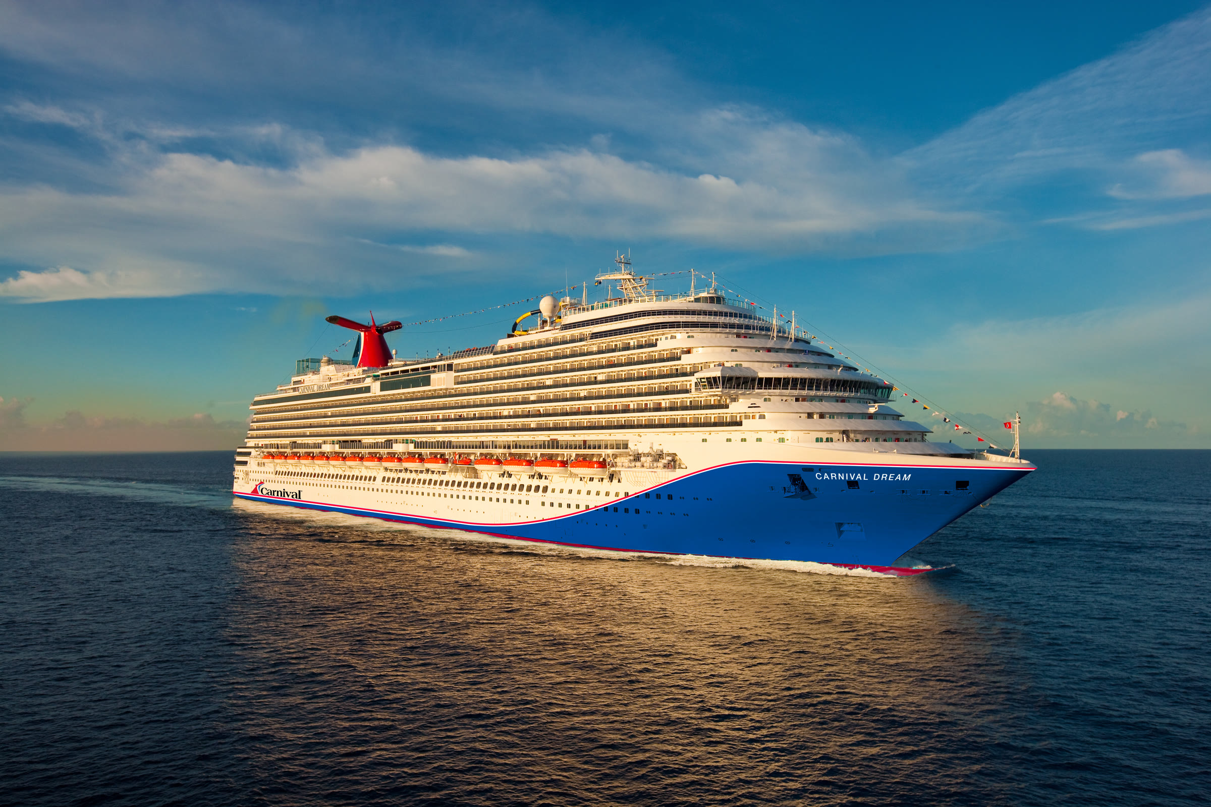 Carnival Dream blue-hull exterior at sea, sunny daylight