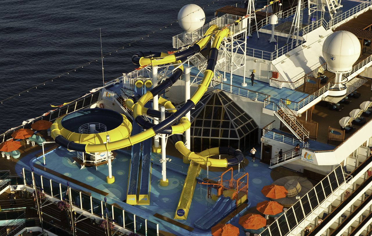 Carnival Dream aerial view of the WaterWorks yellow and blue slides and orange umbrellas