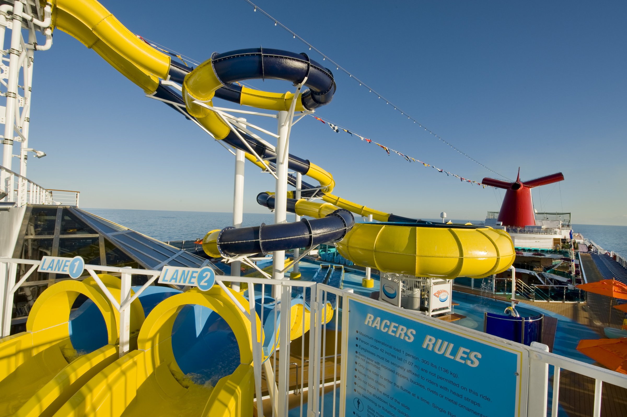 Carnival Dream WaterWorks racer slides and blue tubes against a bright sky