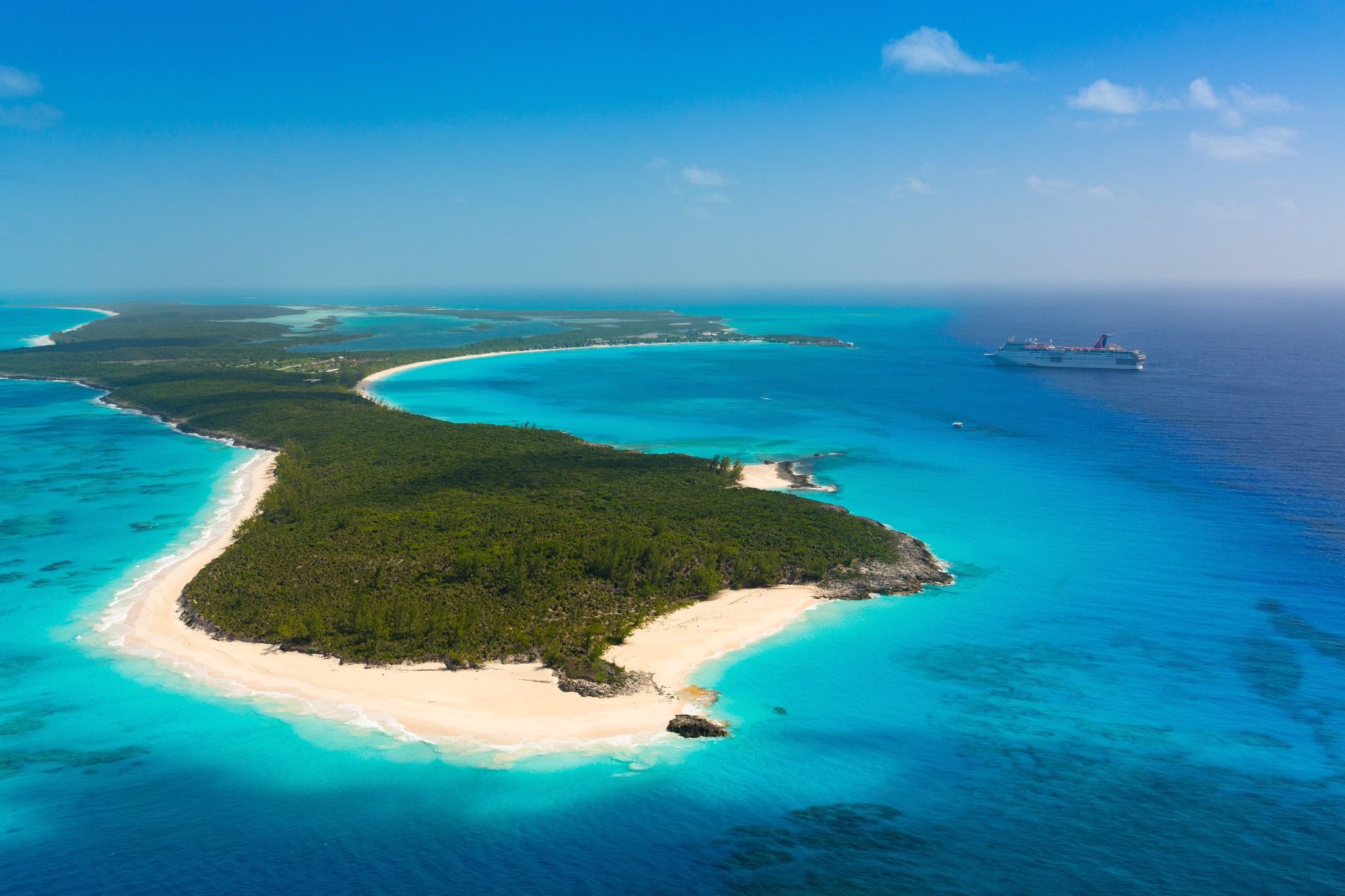 Carnival Elation off Half Moon Cay, aerial of the island and turquoise water under blue sky