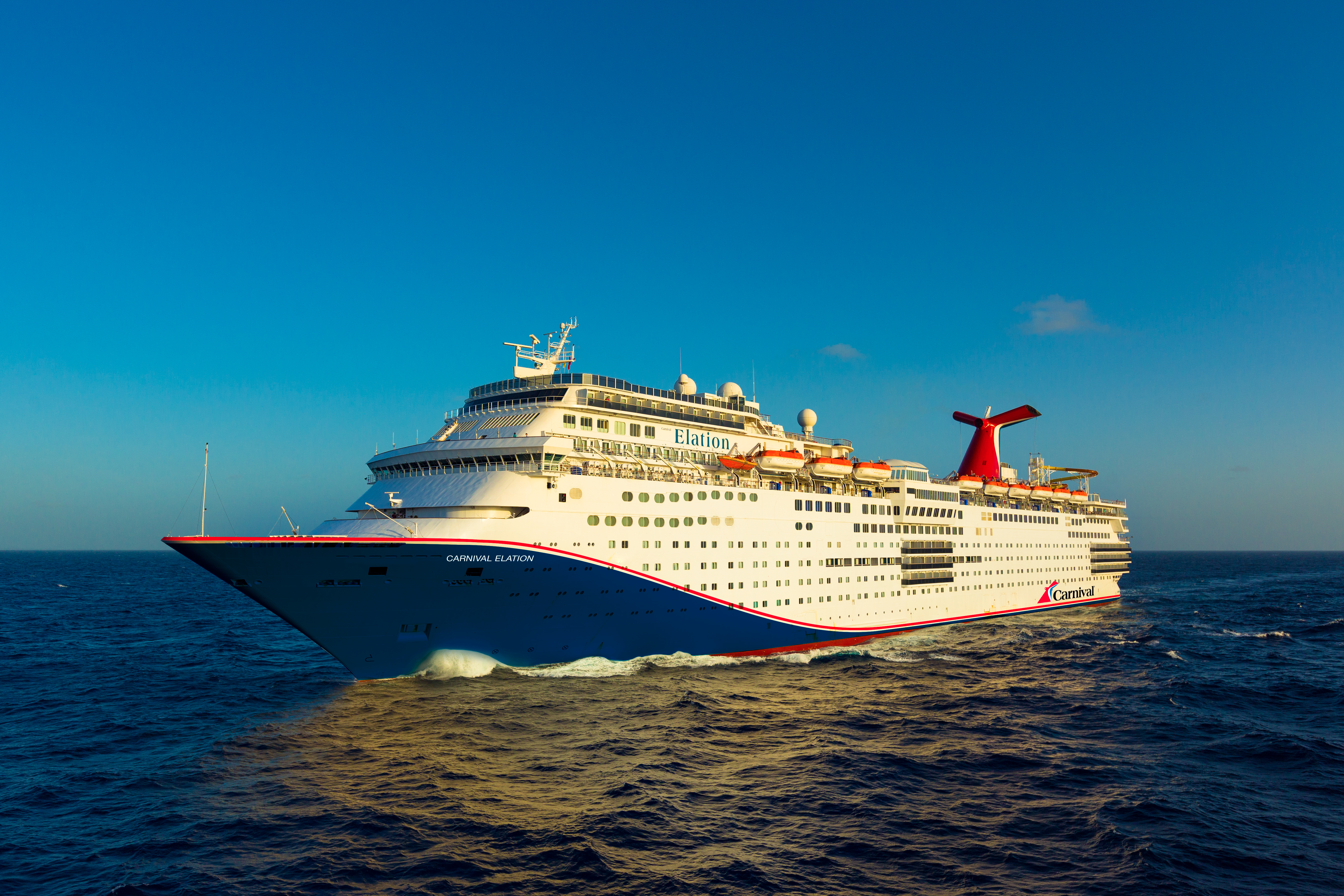 Carnival Elation blue hull aerial underway under a clear sky