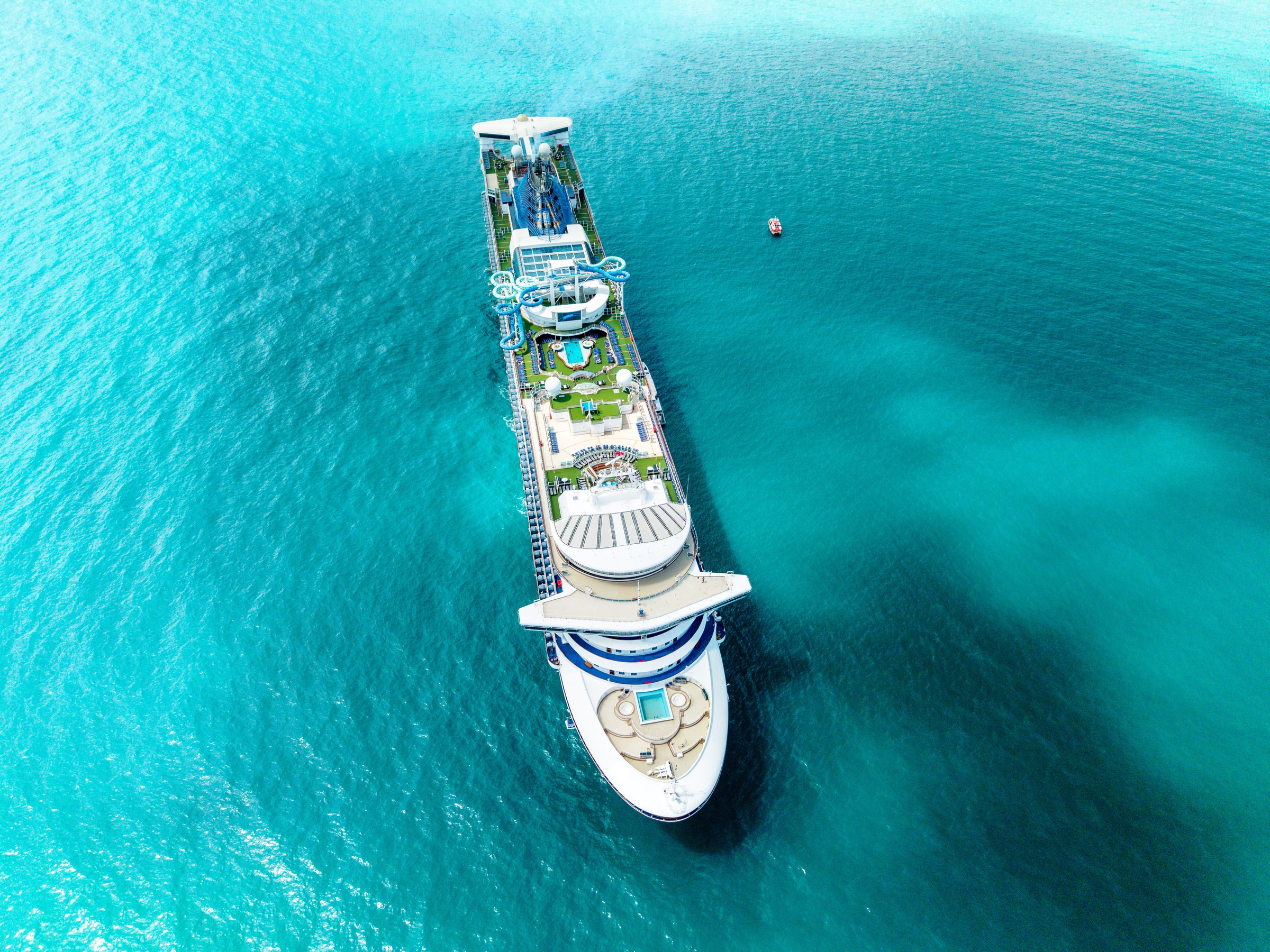 Carnival Encounter seen from directly above at anchor, showing the full length of its top decks