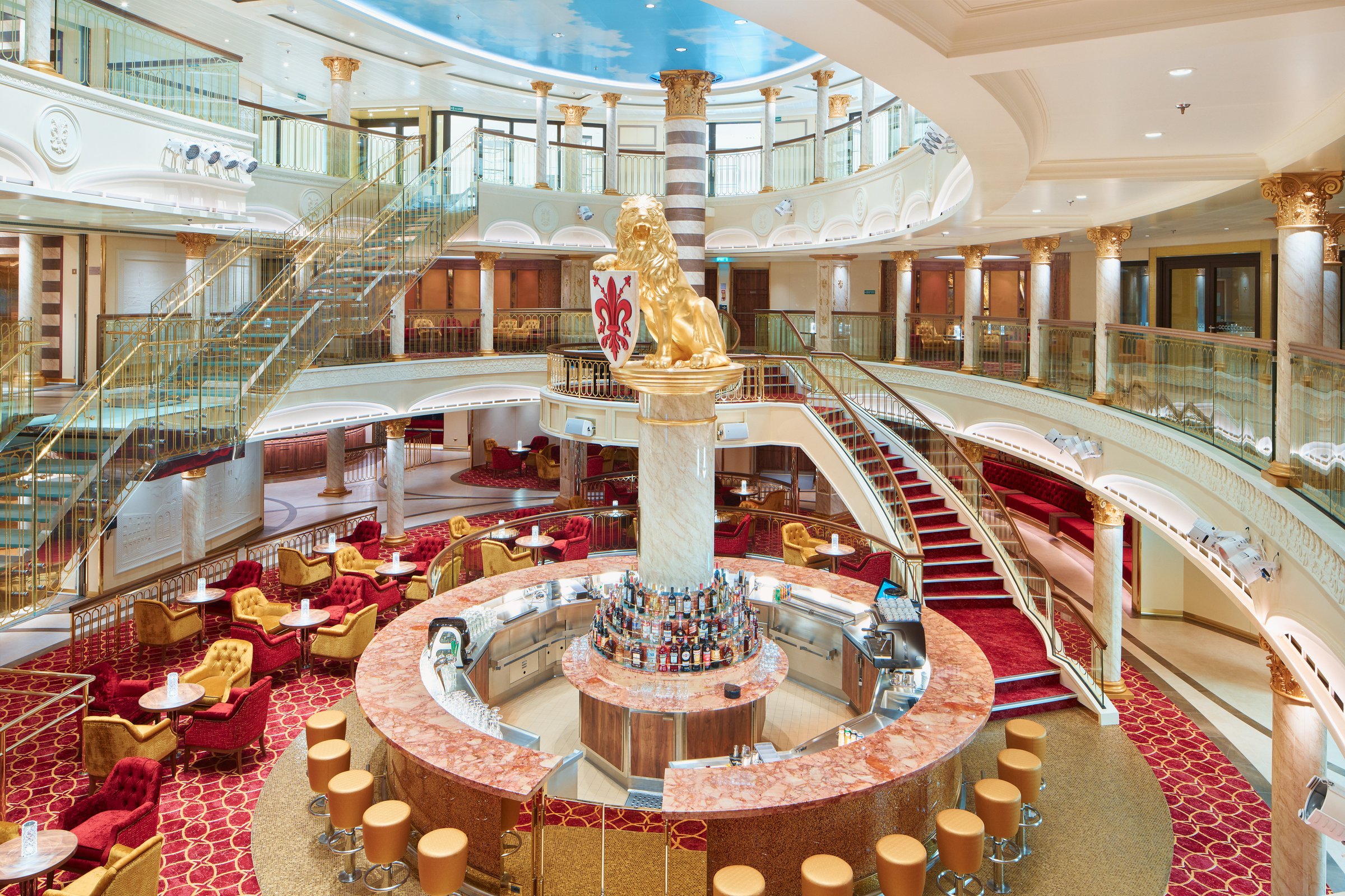 Carnival Firenze Piazza della Signoria atrium with a circular central bar, red staircase and gold lion column