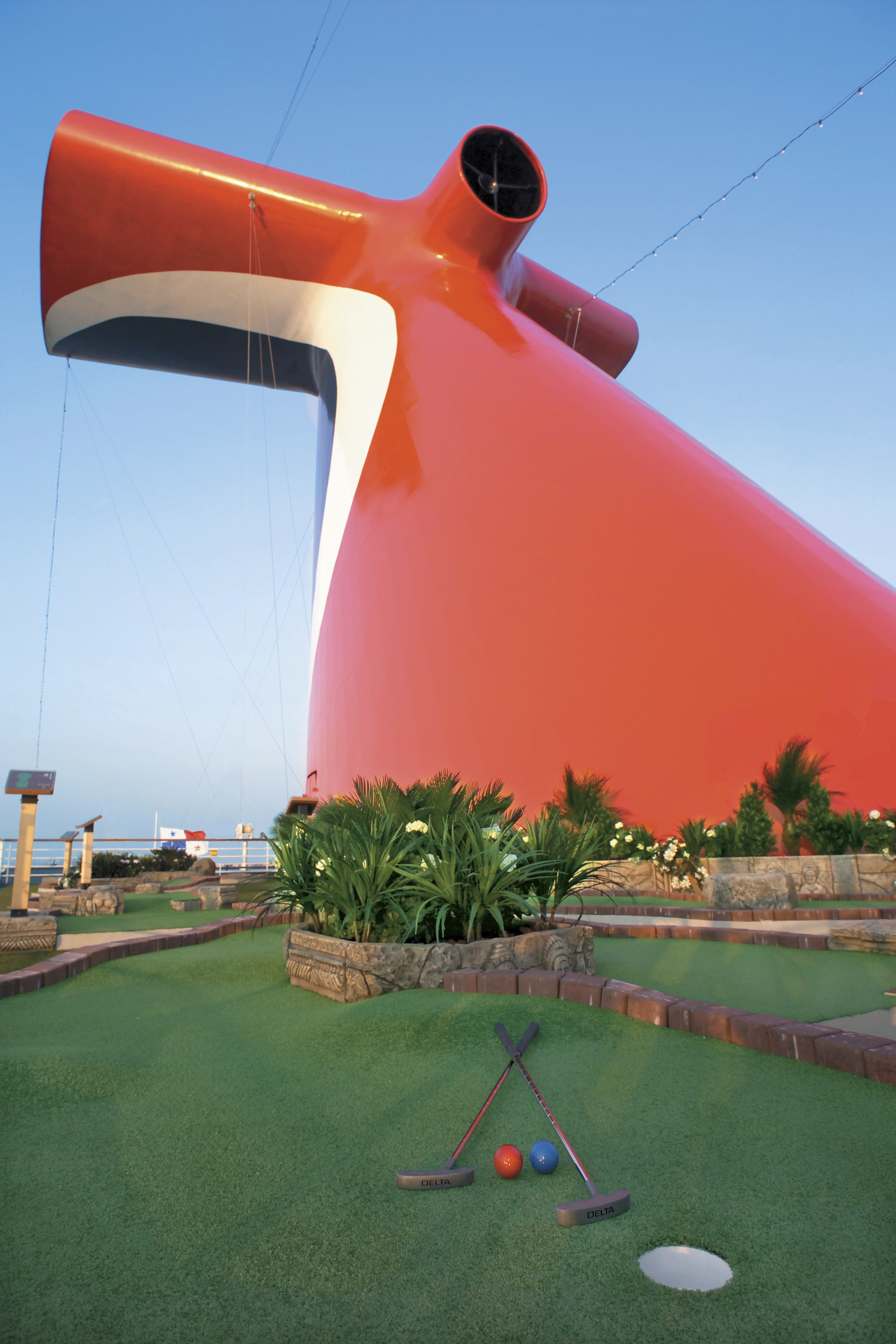 Carnival Freedom mini golf under red funnel, clear blue sky