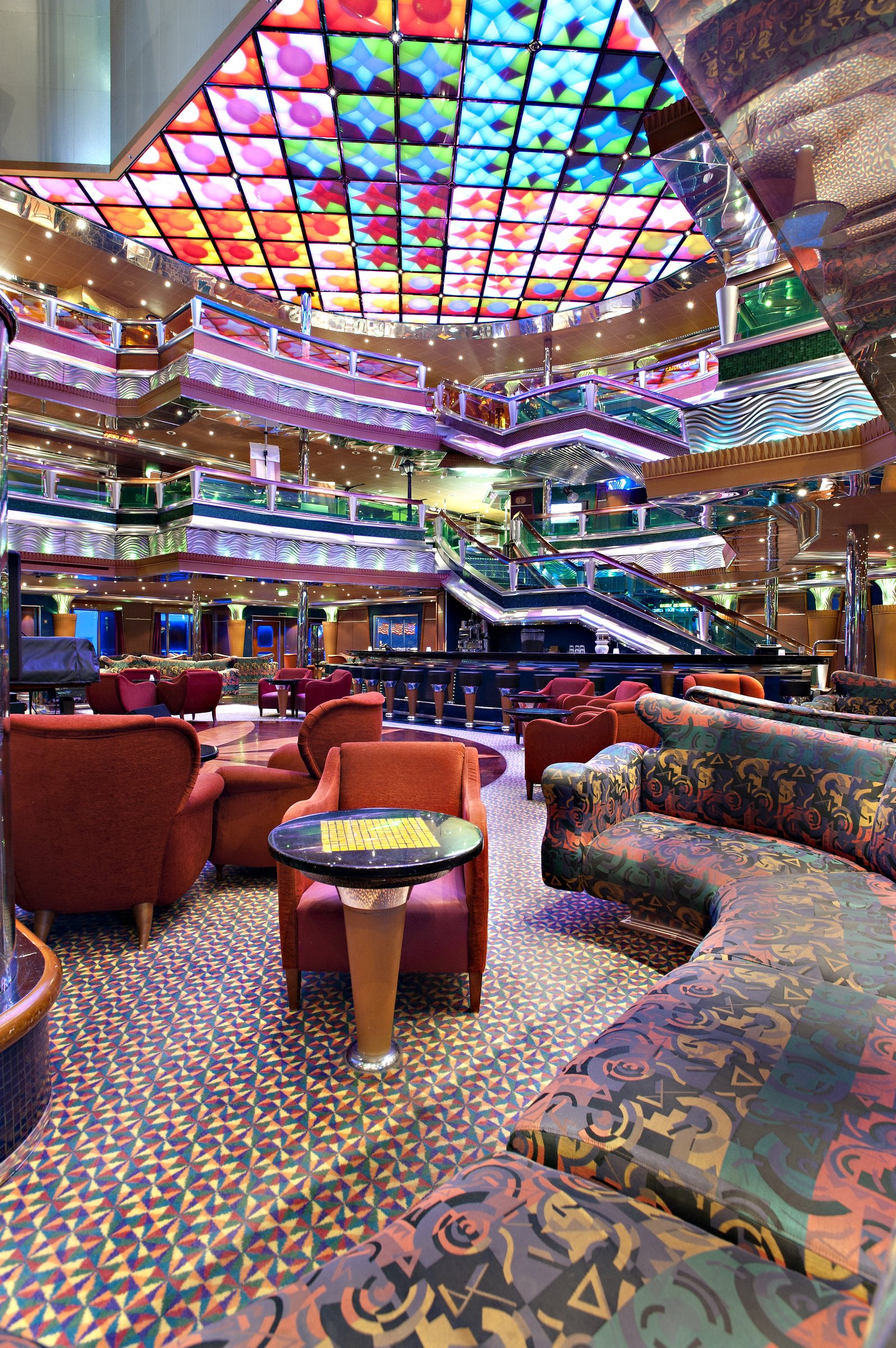 Carnival Glory multi-deck atrium with stained-glass ceiling and lounge seating