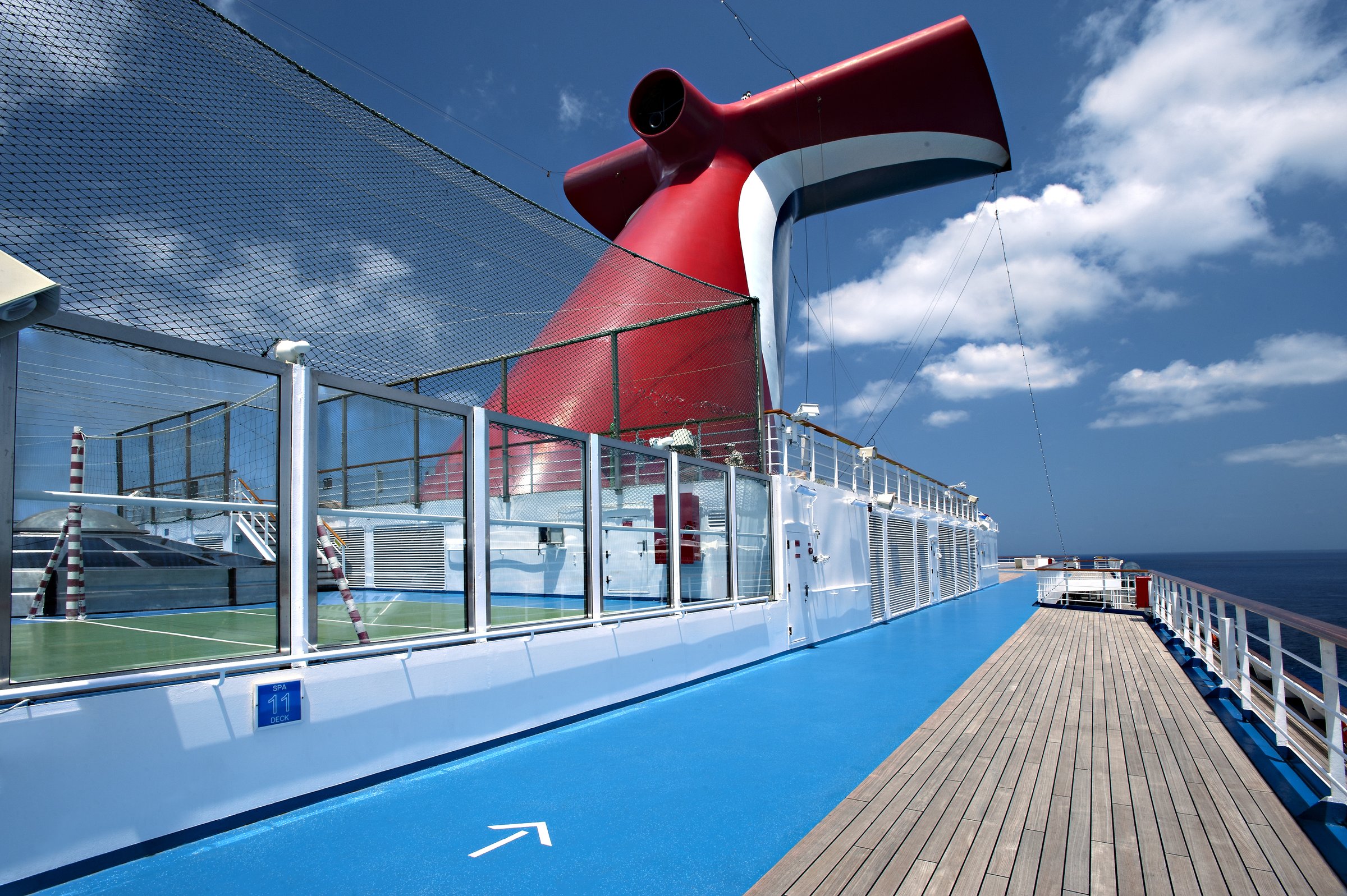 Carnival Glory jogging track beside the sports court with the red funnel and blue sky