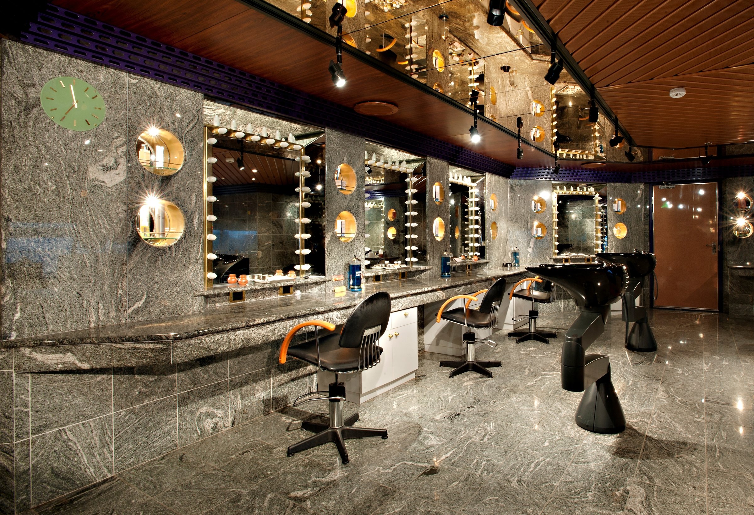 Carnival Glory beauty salon with styling chairs and lit vanity mirrors