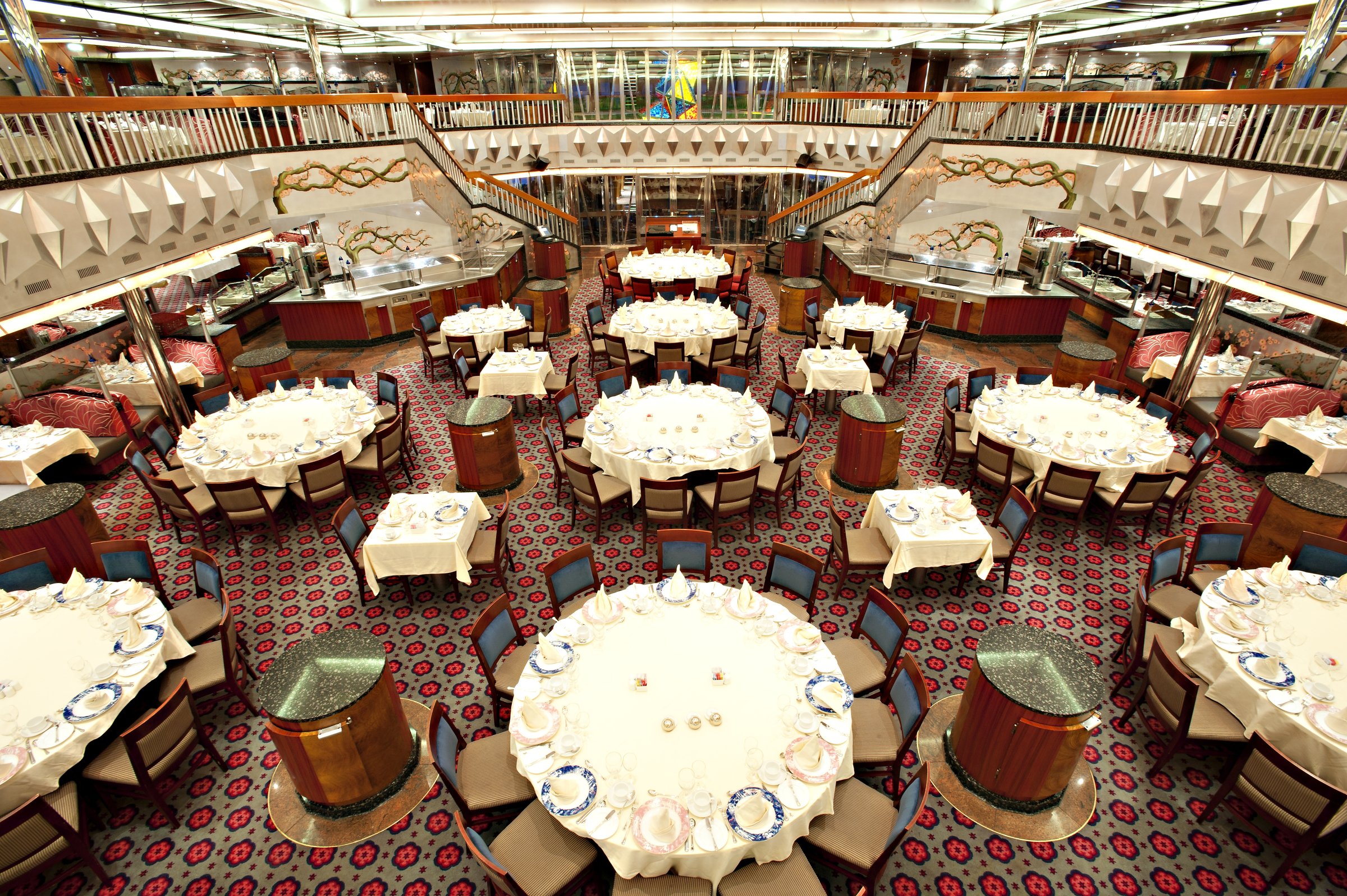 Carnival Glory Platinum dining room with set round tables seen from above