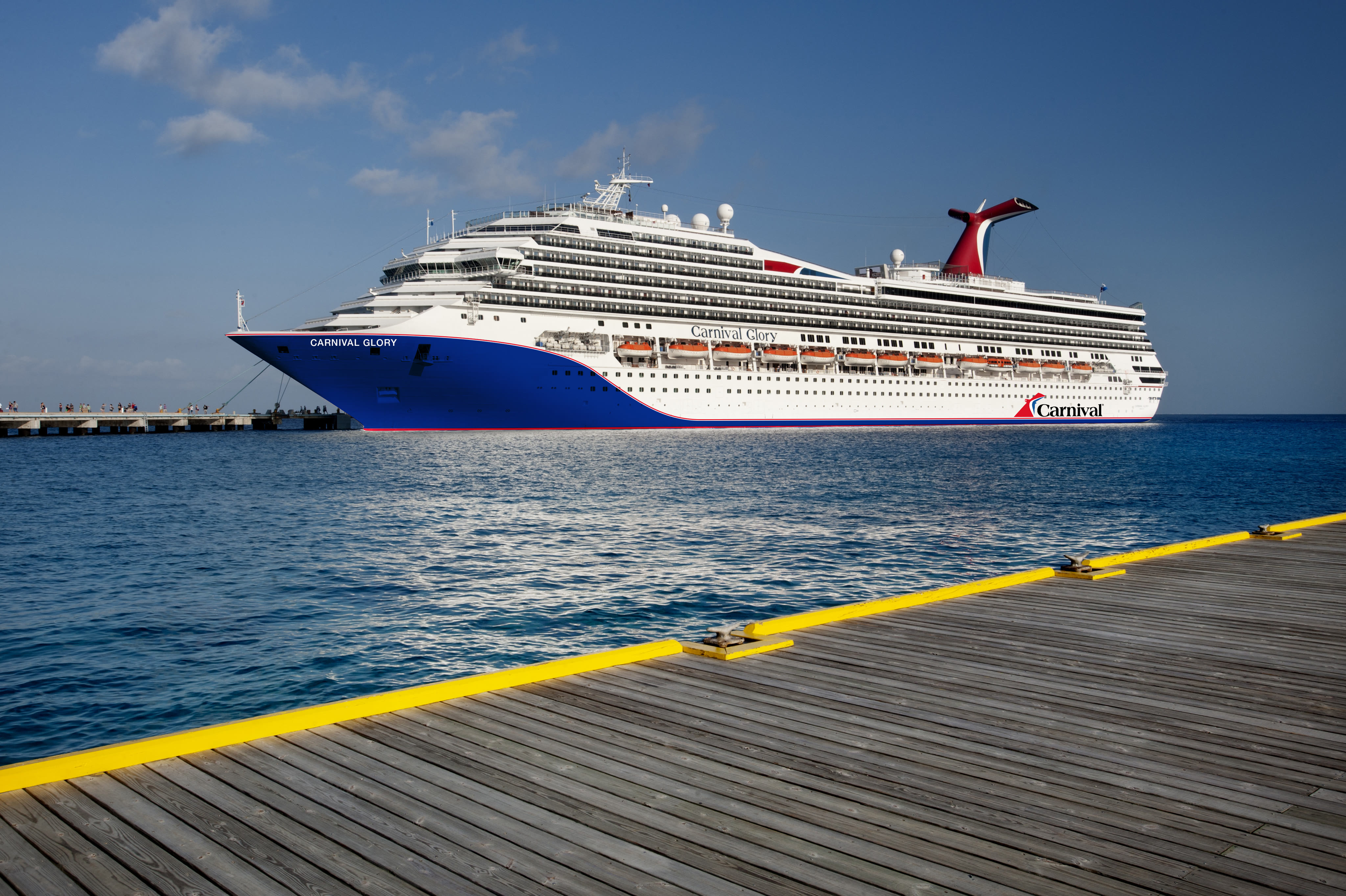 Carnival Glory blue hull at Cozumel pier under clear sky