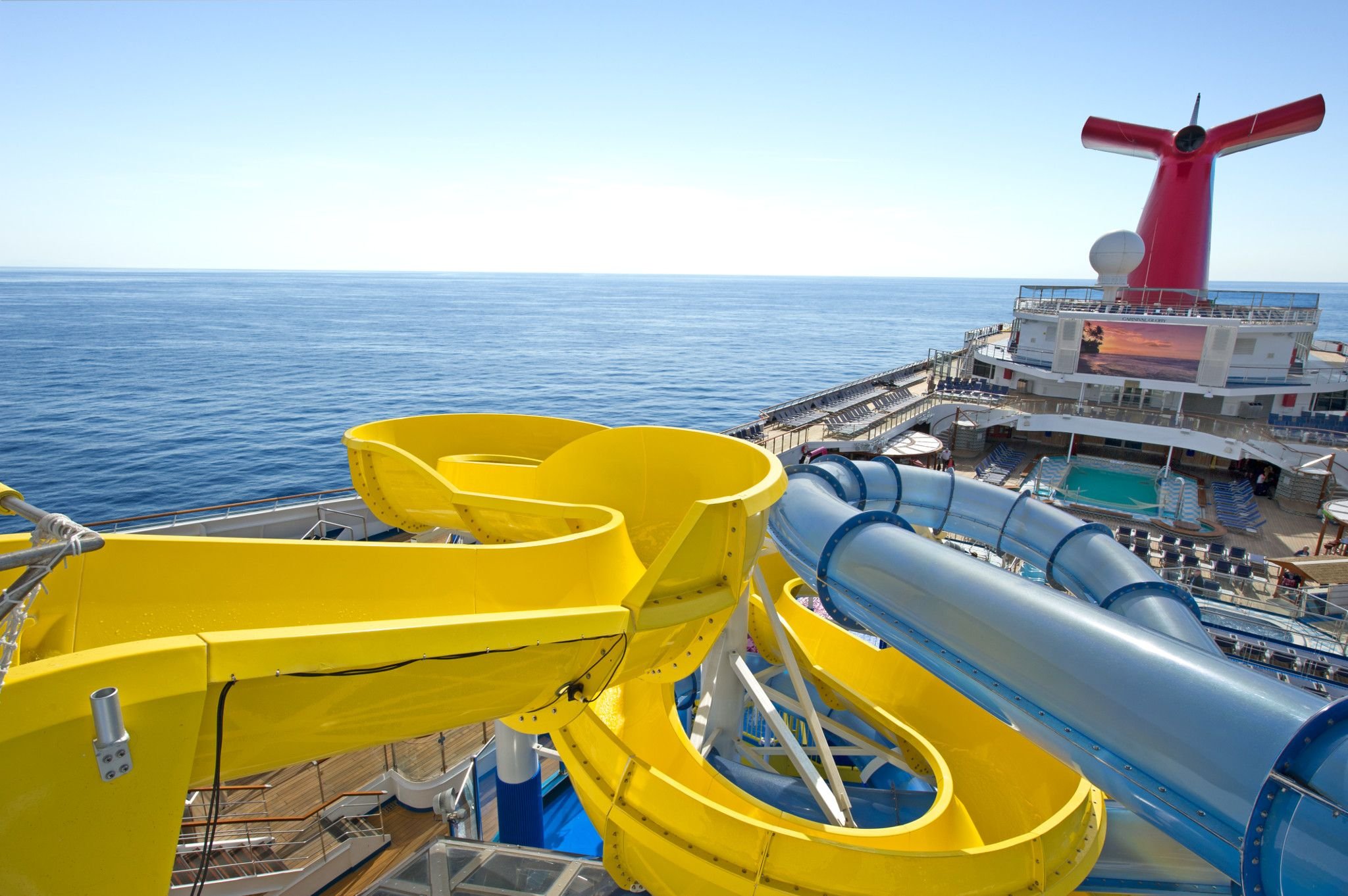 Carnival Glory WaterWorks slides overlooking the pool deck, funnel and open sea