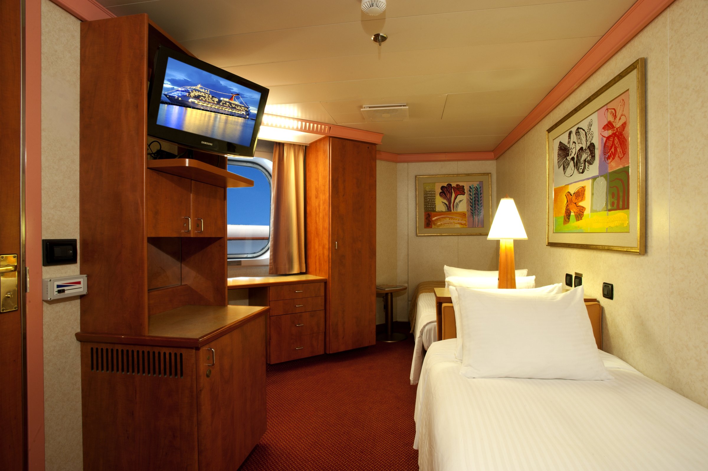Carnival Glory interior stateroom with twin beds, wardrobe and TV