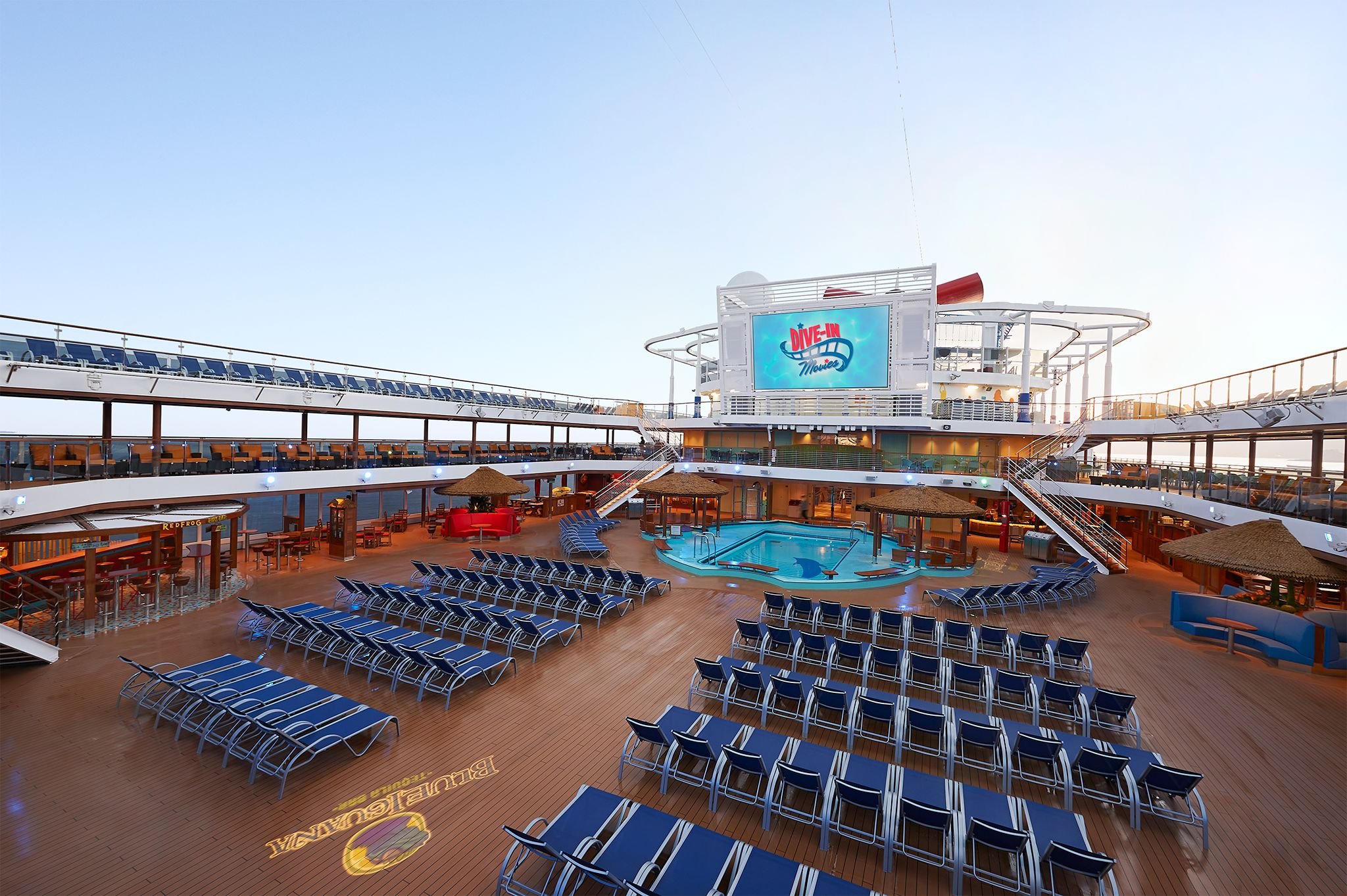 Carnival Horizon Lido pool deck with rows of blue loungers and the Dive-In Movies screen