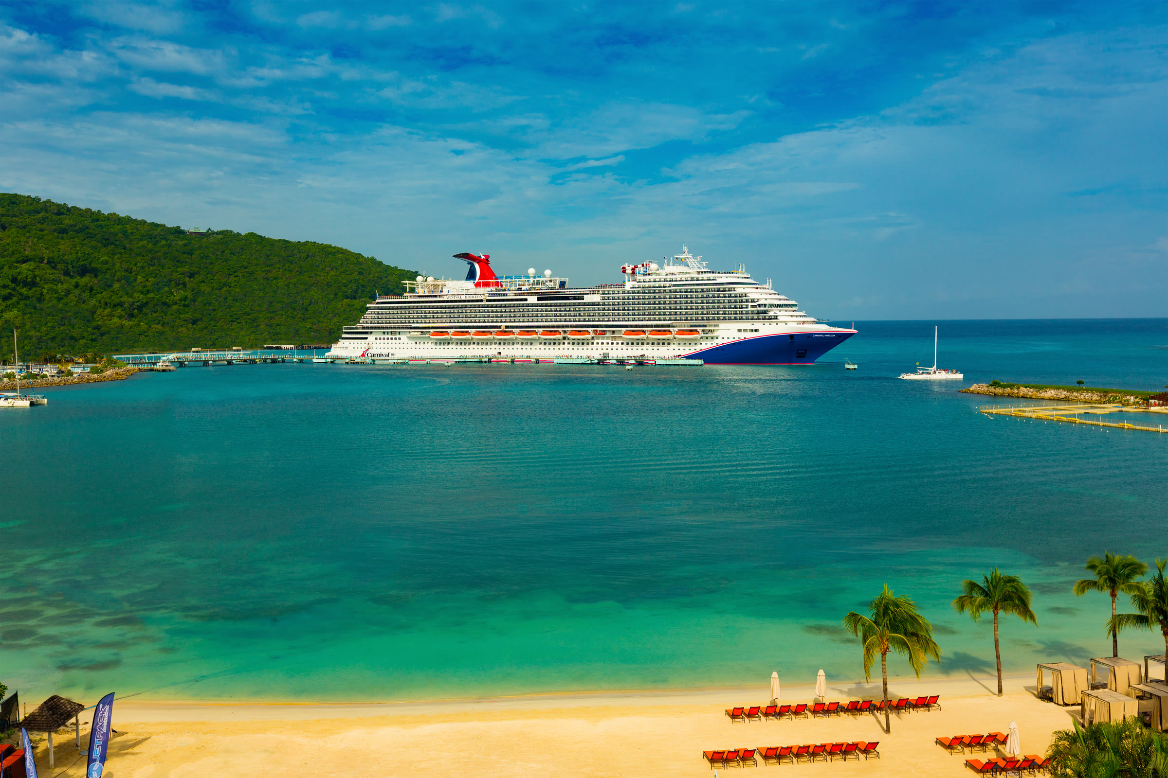 Carnival Horizon sunny blue-hull exterior at tropical bay