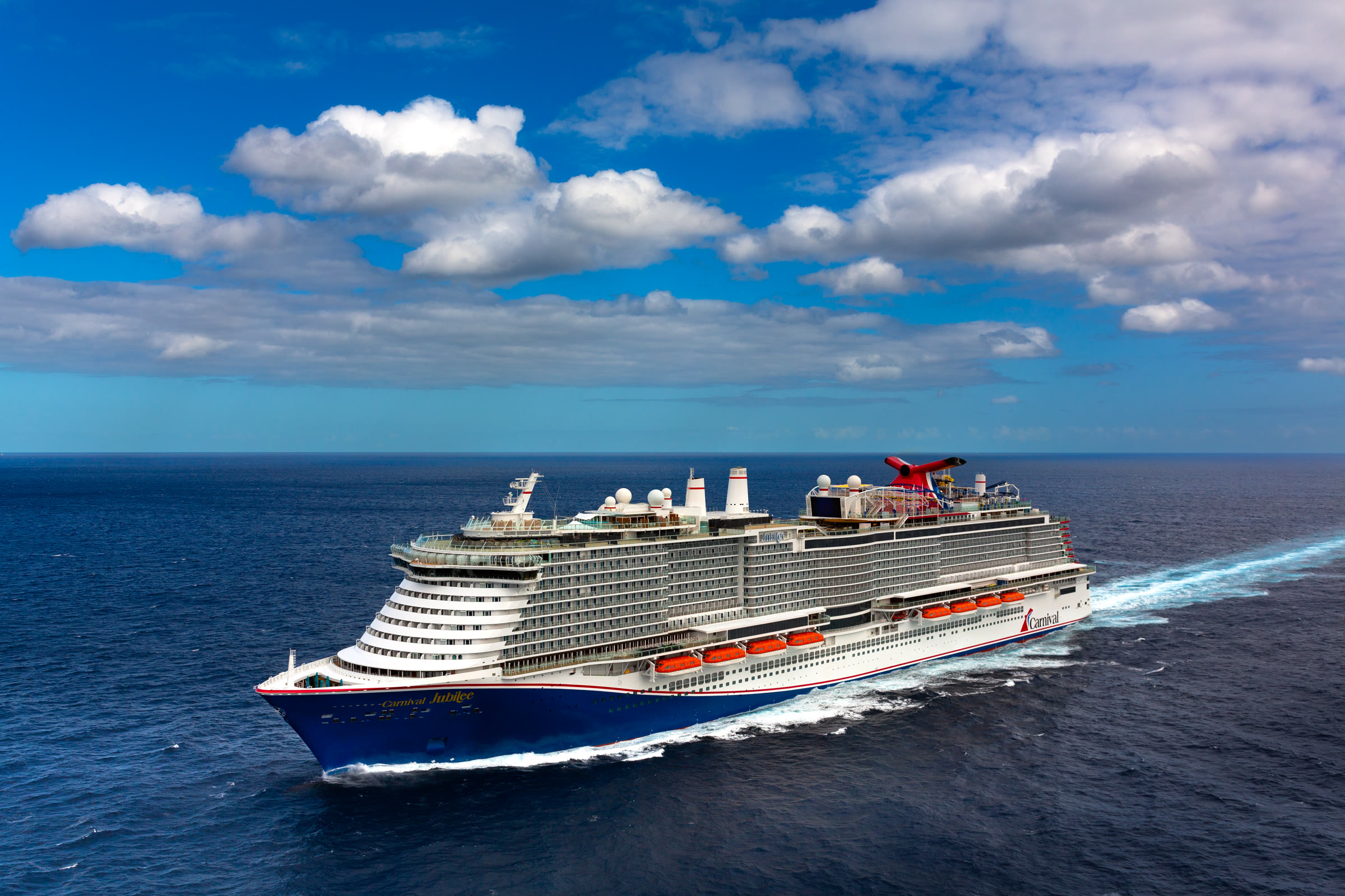 Carnival Jubilee sunny aerial open-ocean exterior with wake