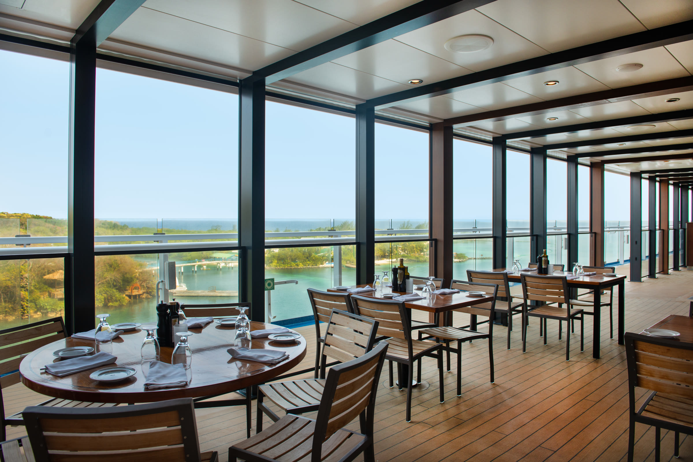 Bright La Cucina dining terrace with tropical bay view aboard Carnival Jubilee