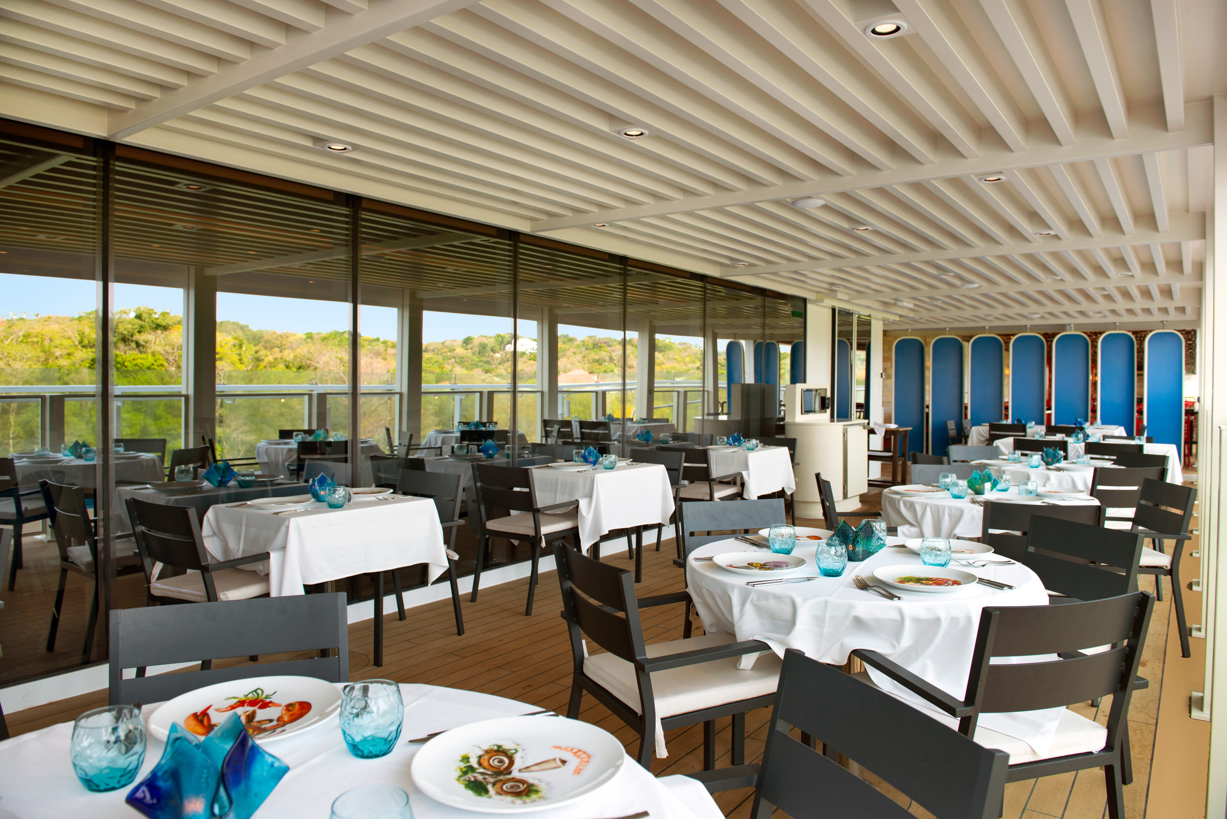 Sunny outdoor dining at Rudi's Seagrill aboard Carnival Jubilee