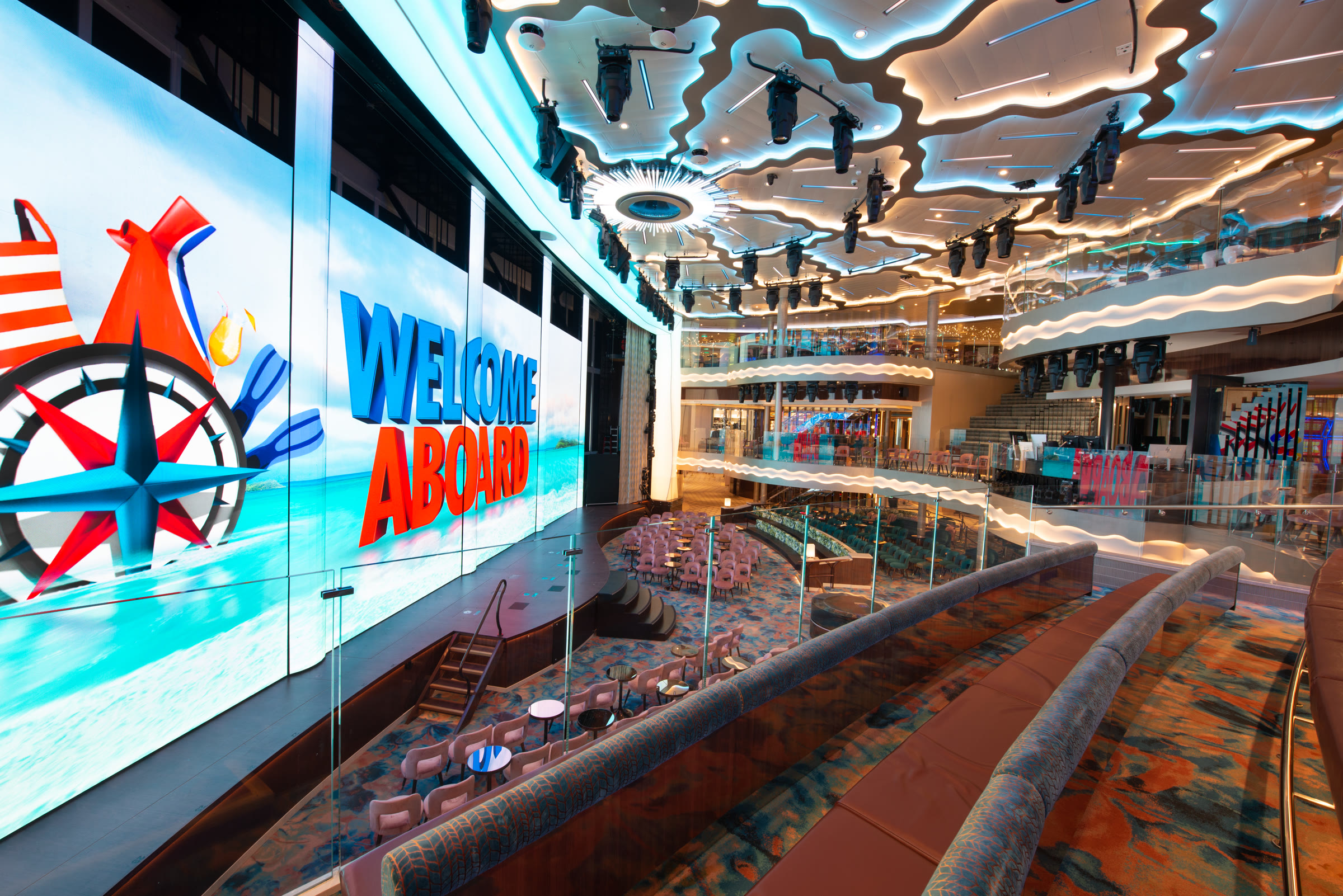 Bright Grand Central atrium with Welcome Aboard screen aboard Carnival Jubilee
