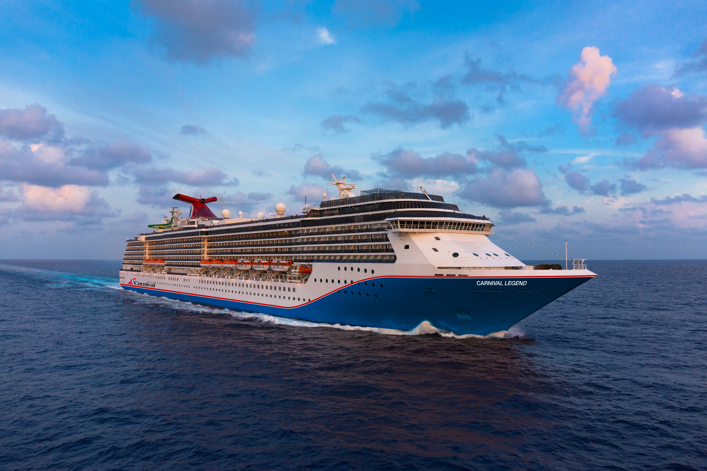 Carnival Legend blue-hull aerial exterior at sea, bright daylight