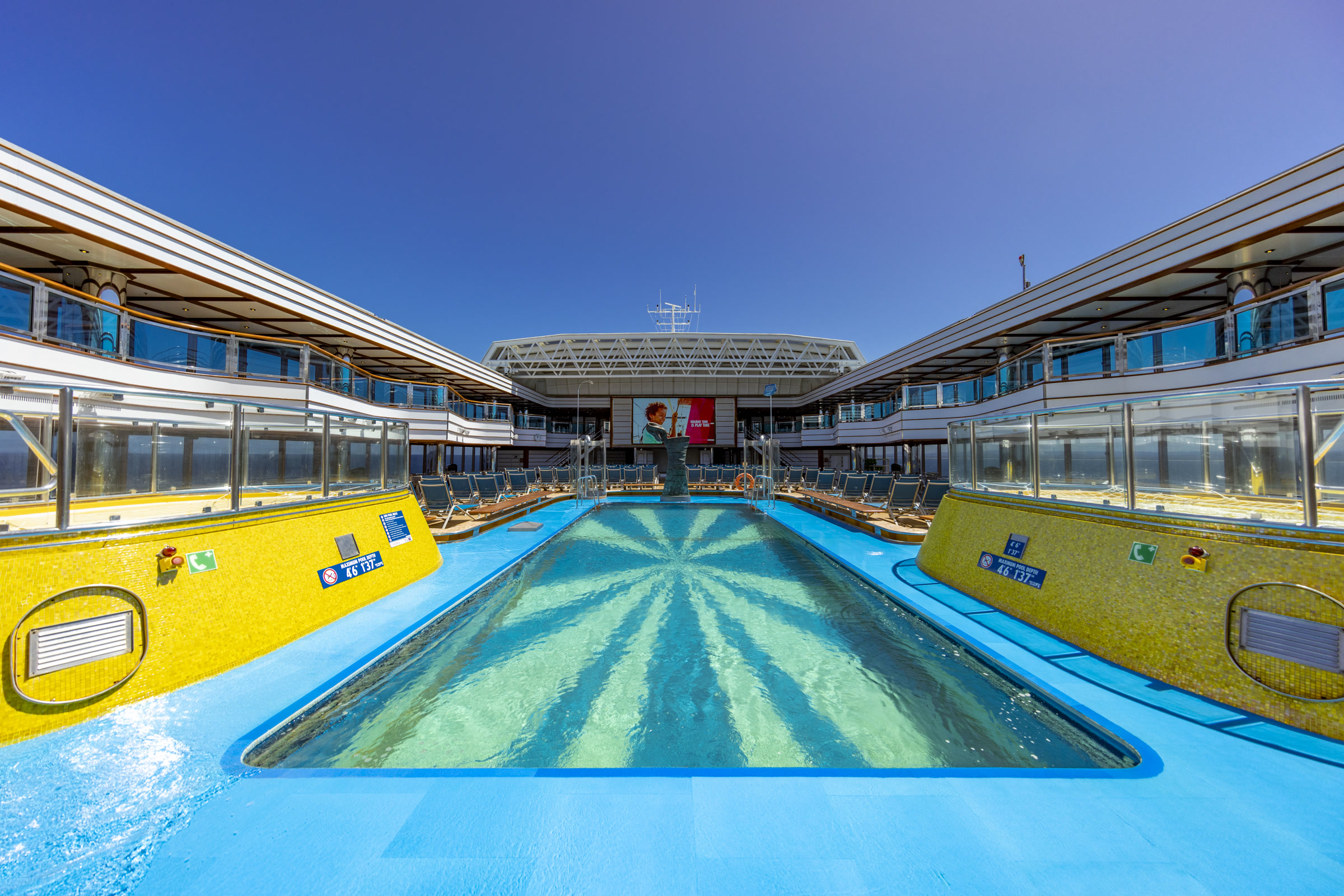 Carnival Luminosa Lido pool midday with blue deck and Seaside Theater screen