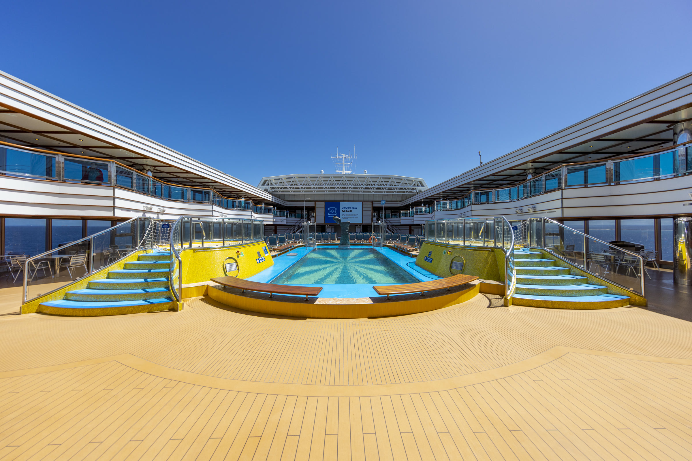 Carnival Luminosa Lido pool with Dive-In Movies screen under clear blue sky