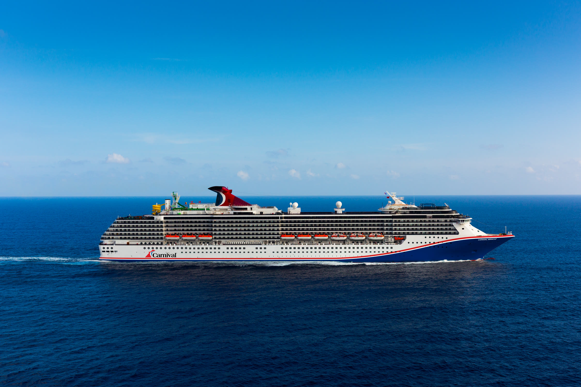 Carnival Miracle blue-hull exterior in sunny open water