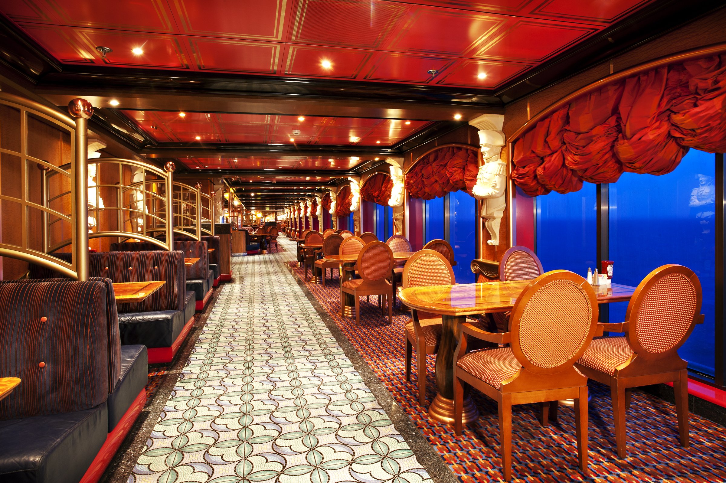 Carnival Miracle Horatio's restaurant with red ceiling, patterned aisle and polished wooden tables by the windows