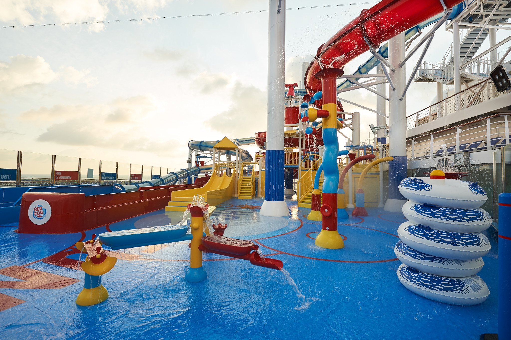 Carnival Panorama WaterWorks splash area with spray cannons, stacked tubes and yellow slides