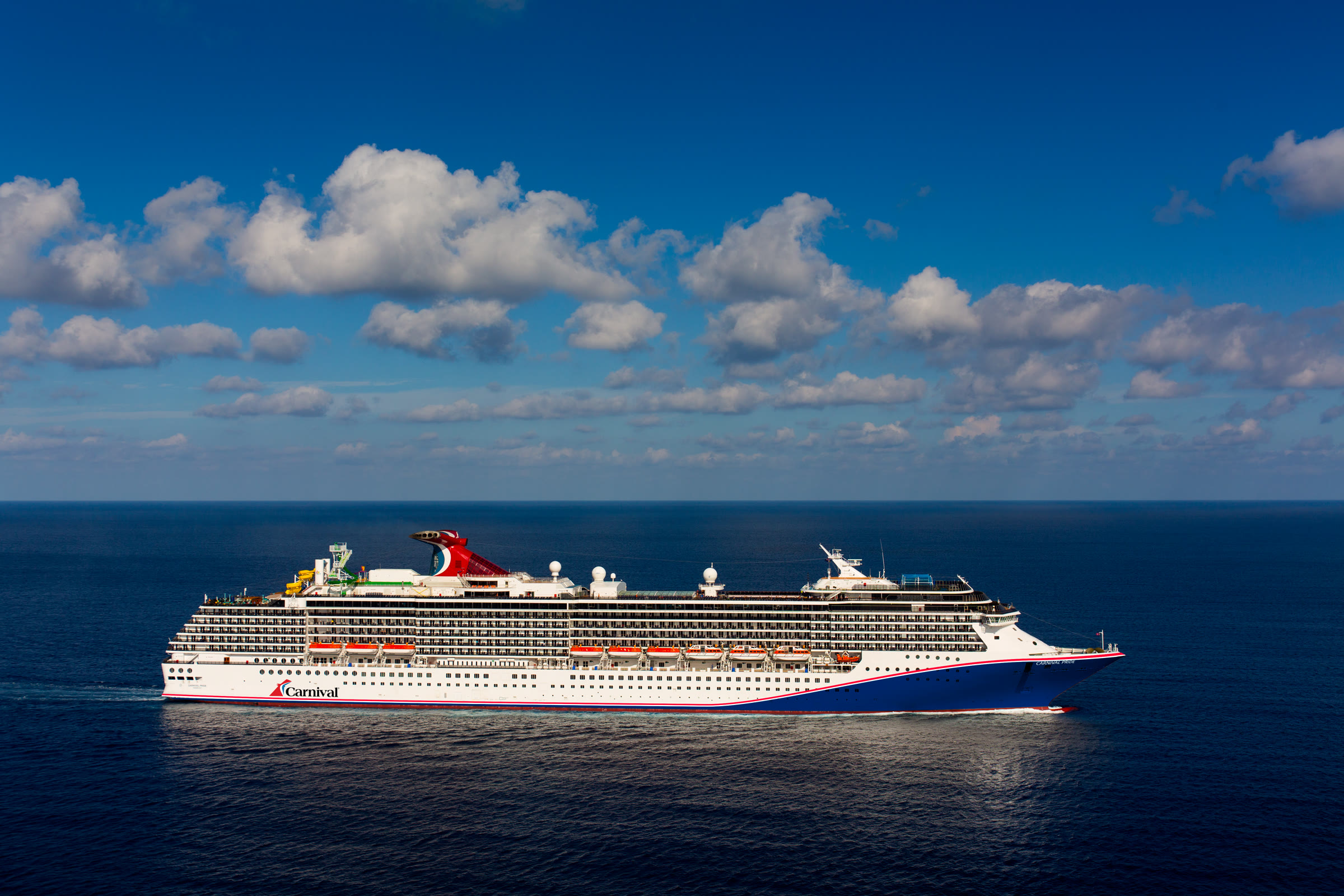 Carnival Pride blue-hull exterior at Grand Cayman, sunny daylight