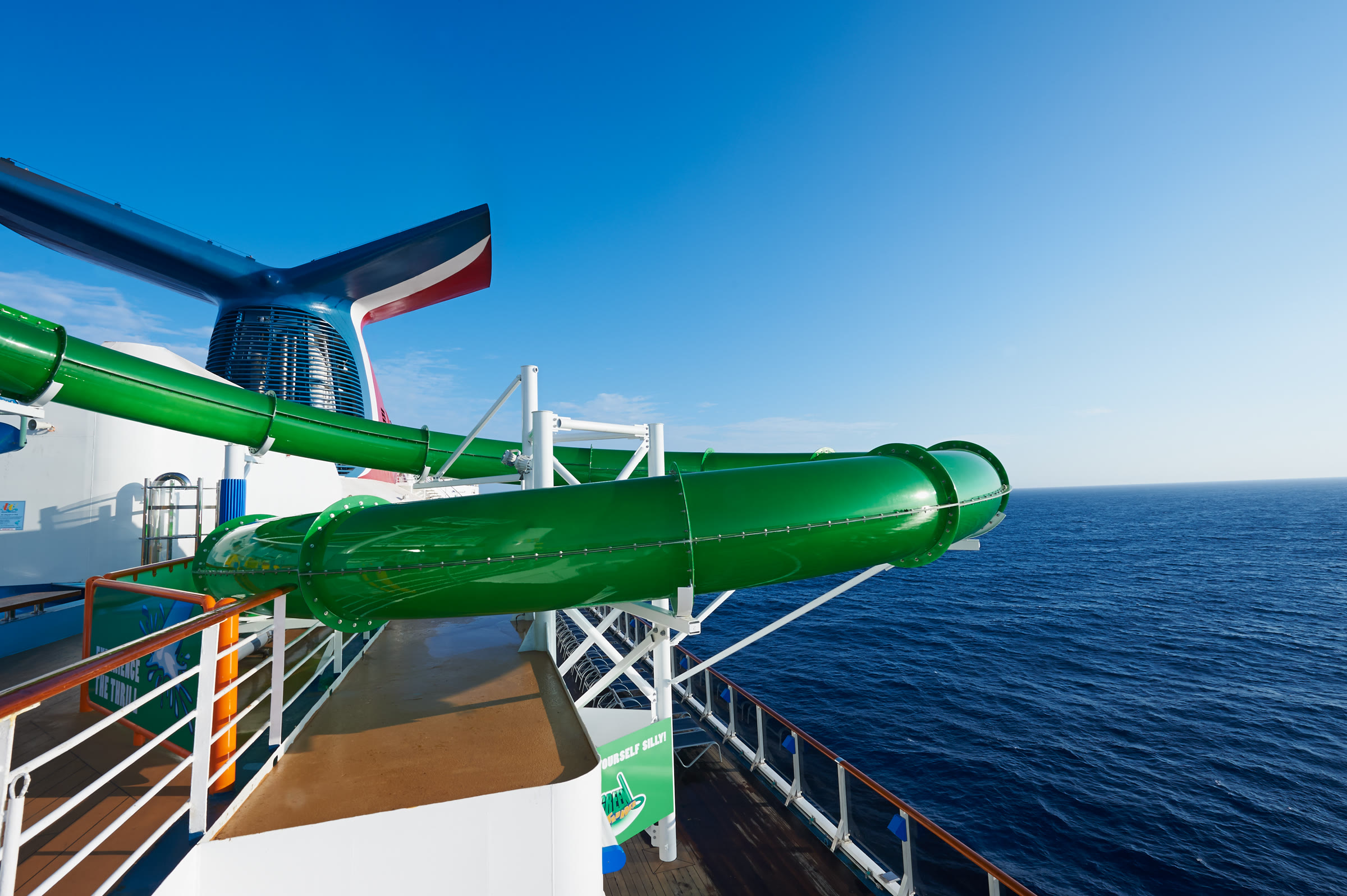 Carnival Pride WaterWorks green waterslide over bright open ocean