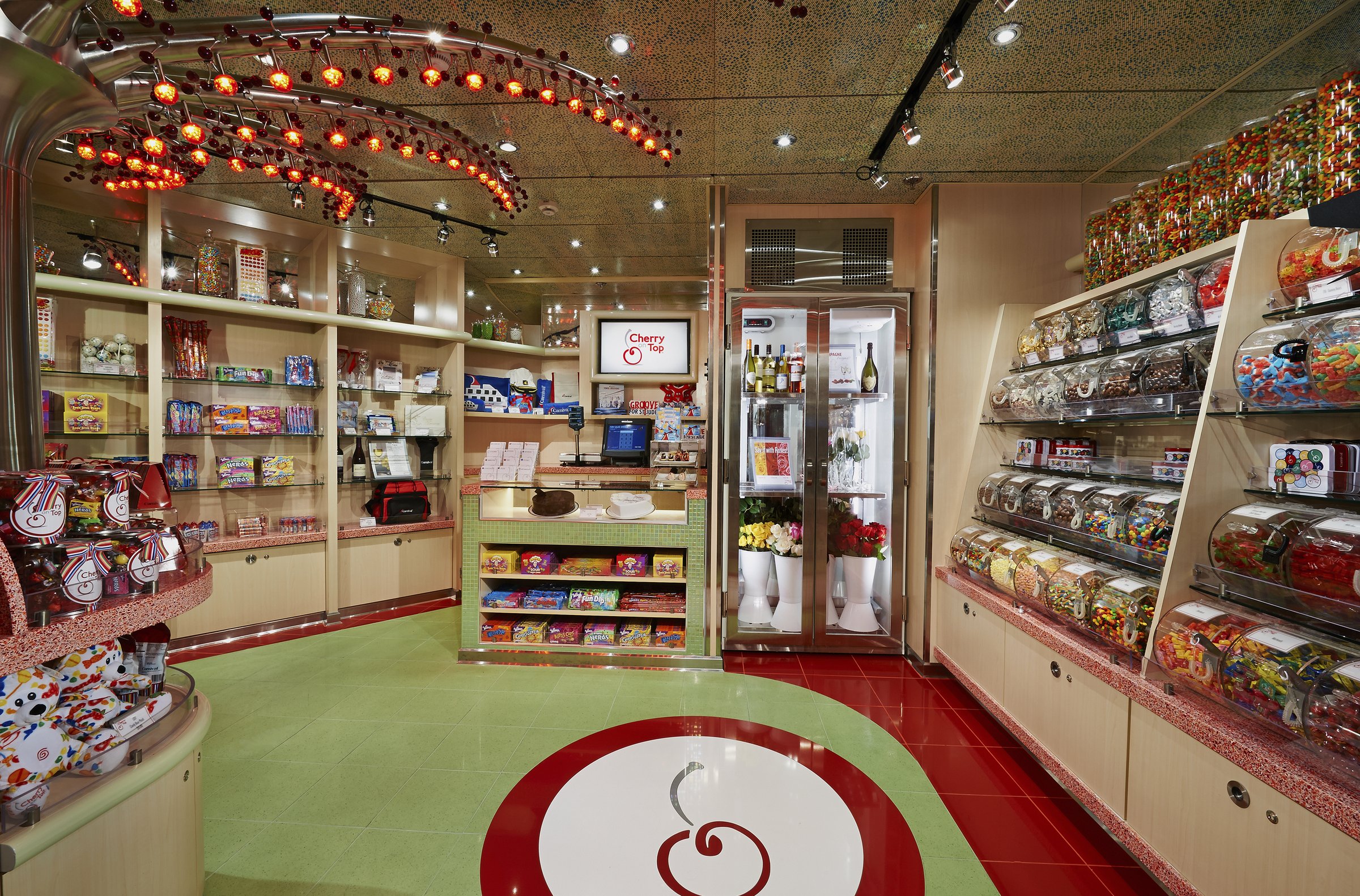Carnival Pride candy shop with shelves of sweets and a red and green floor