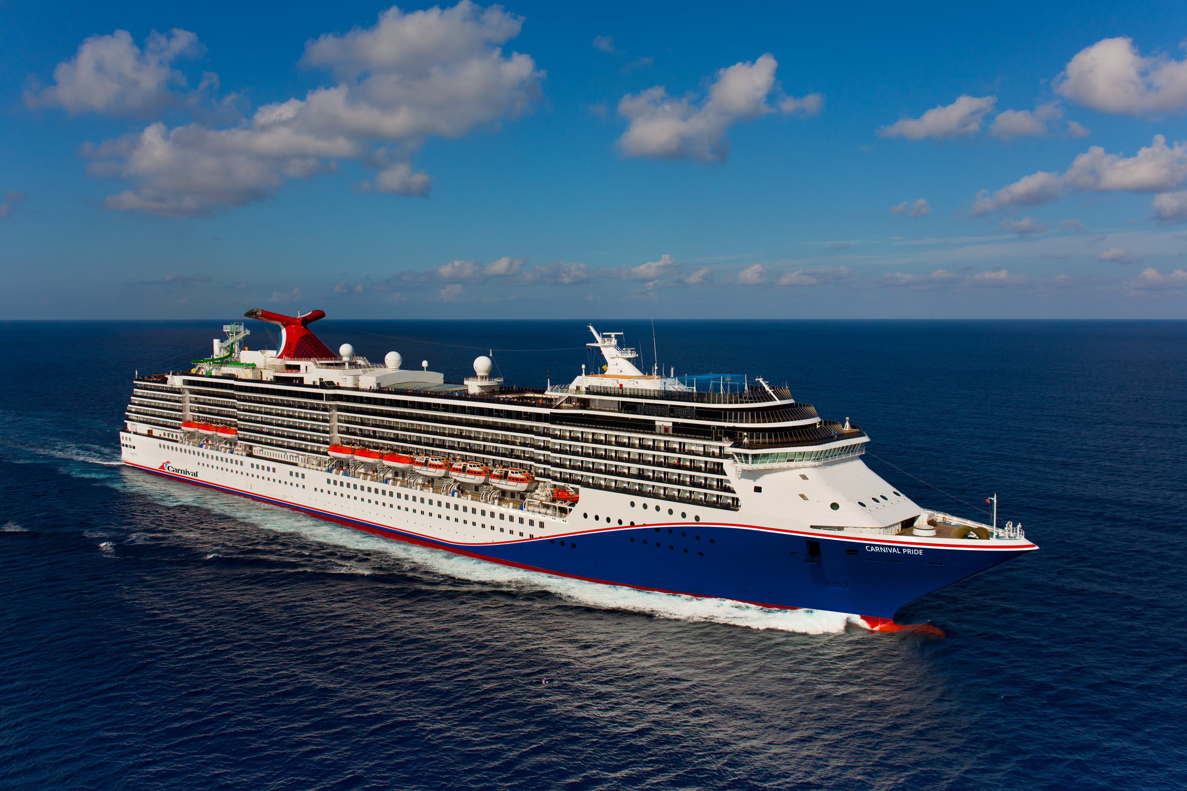 Carnival Pride blue-hull exterior at sea, sunny daylight