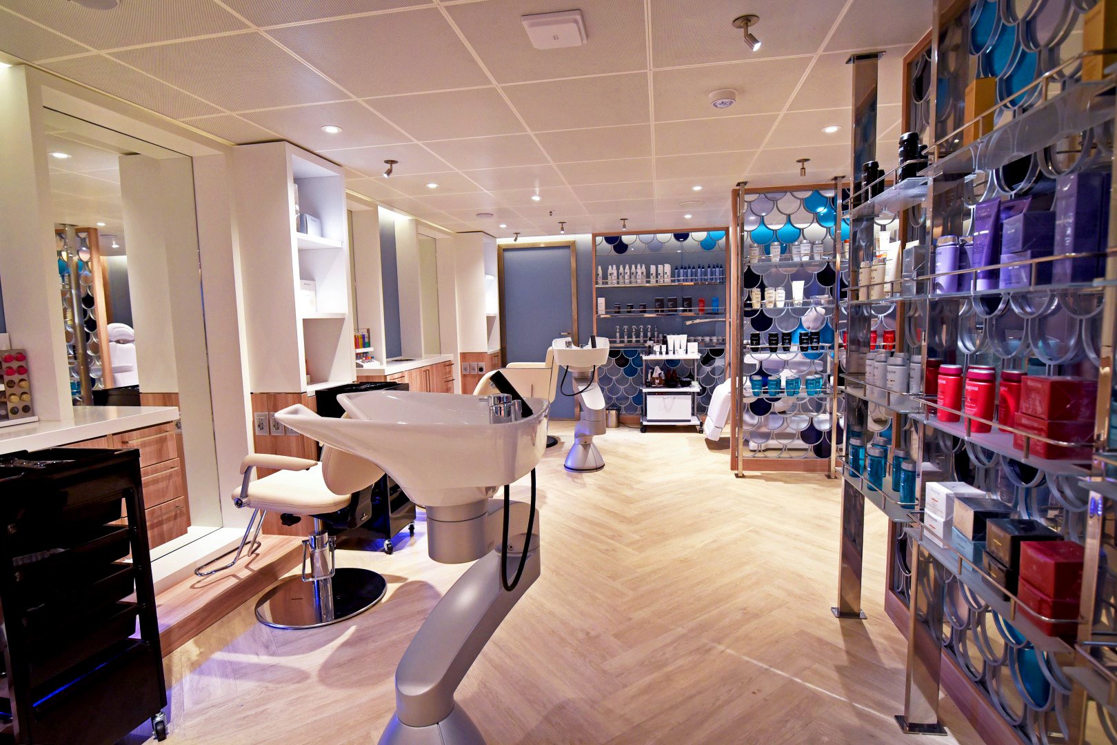 Carnival Radiance beauty salon with a shampoo basin, styling chair and product shelves