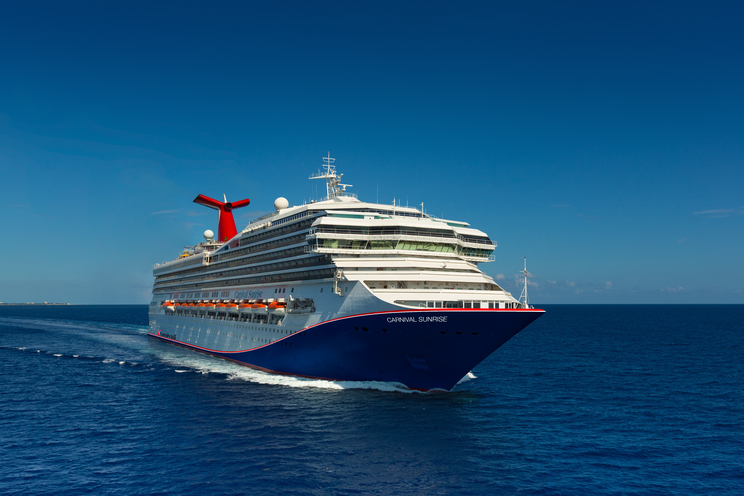 Carnival Sunrise blue-hull bow exterior at sea, bright sunny daylight